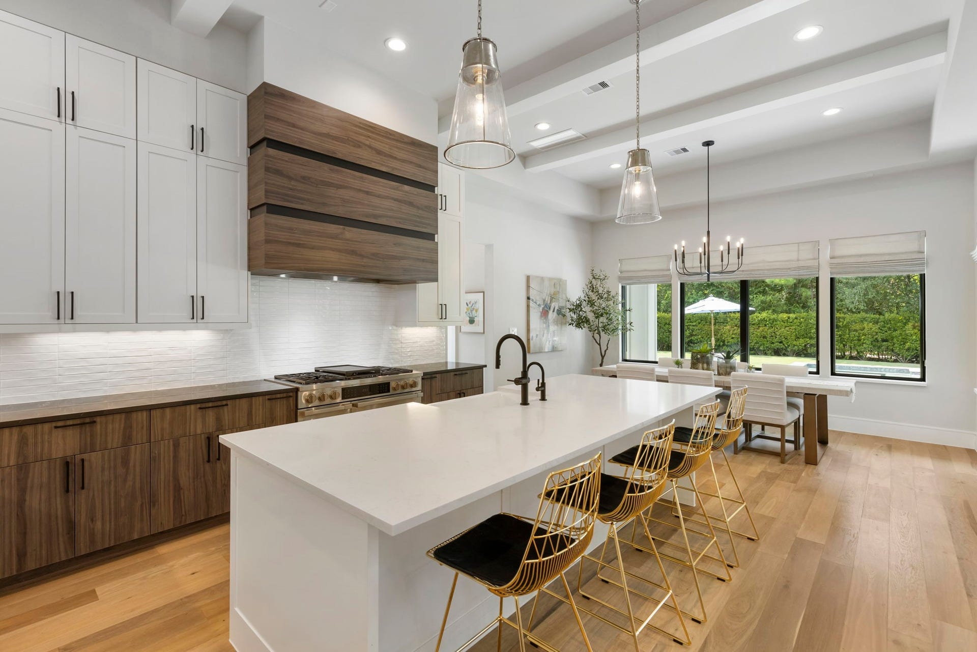 Lastly, the kitchen features gorgeous white subway tile to further compliment the warmer cabinetry, vent hood and countertop.