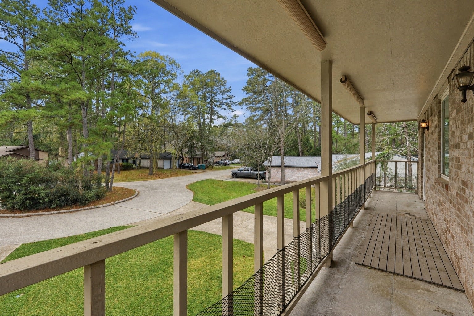 10 E Broken Oak Court, Spring, TX 77381 Covered second-story porch shared by the primary suite and secondary bedroom, offering a unique outdoor space with cul-de-sac views.