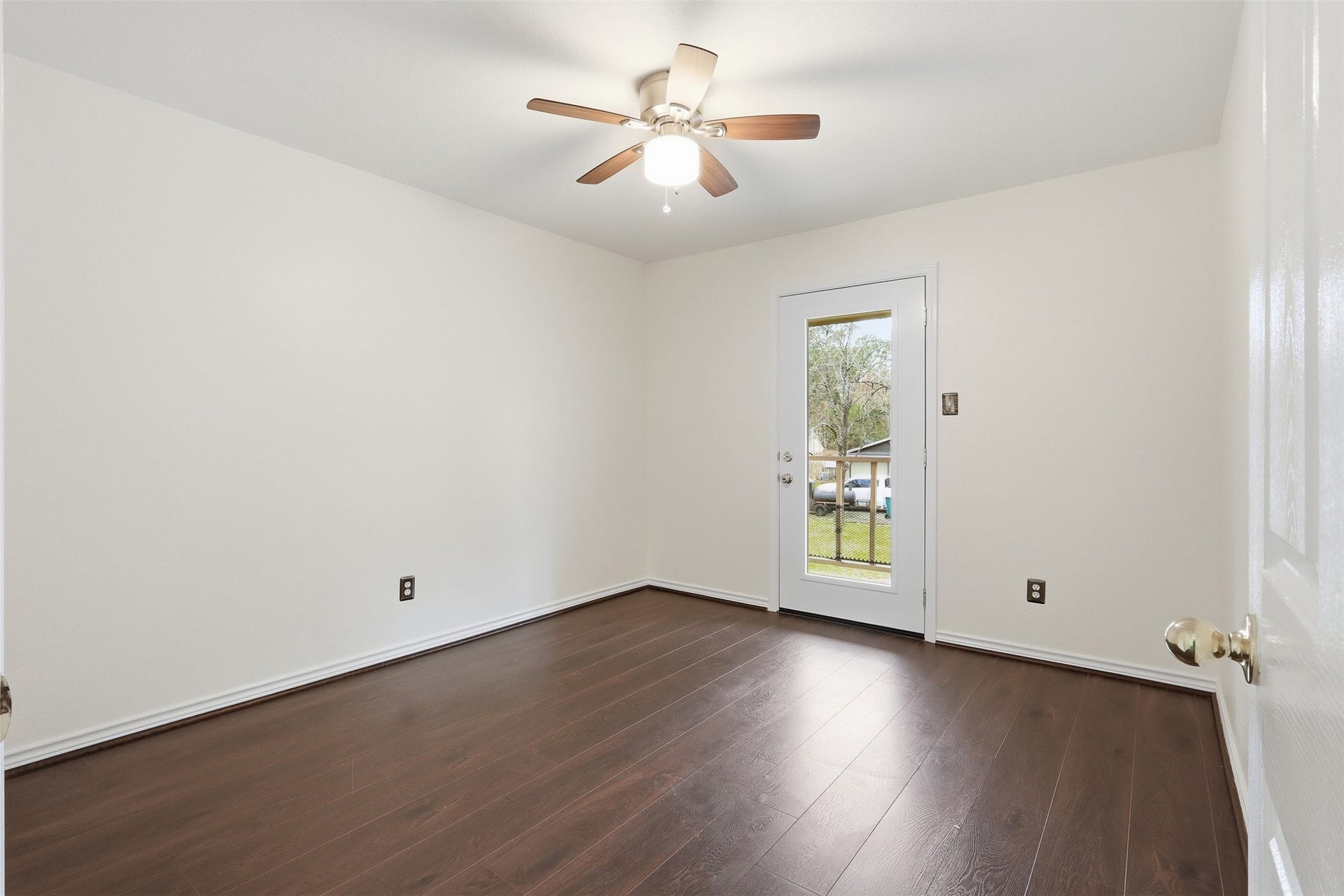 10 E Broken Oak Court, Spring, TX 77381 Secondary bedroom with connected balcony access and view of the charming neighborhood street.