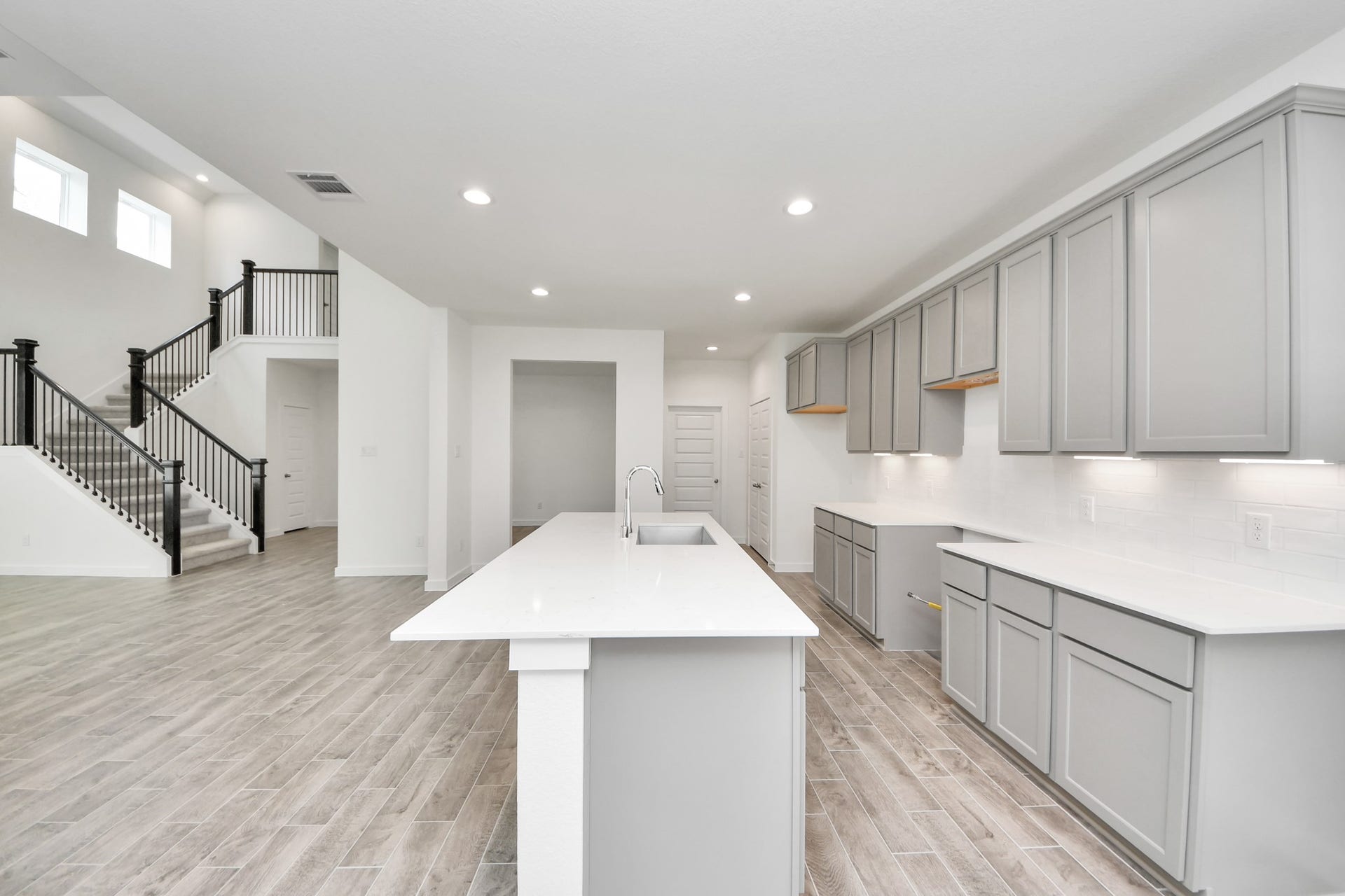 19046 Cape Capasso Drive, Hockley, TX 77447 The open concept effortlessly connects the kitchen to the expansive family room, forming a perfect hub for gatherings. This seamless flow creates an inviting space where cooking and socializing come together harmoniously. Sample photo of completed home with similar floor plan. Actual colors and selections may vary.