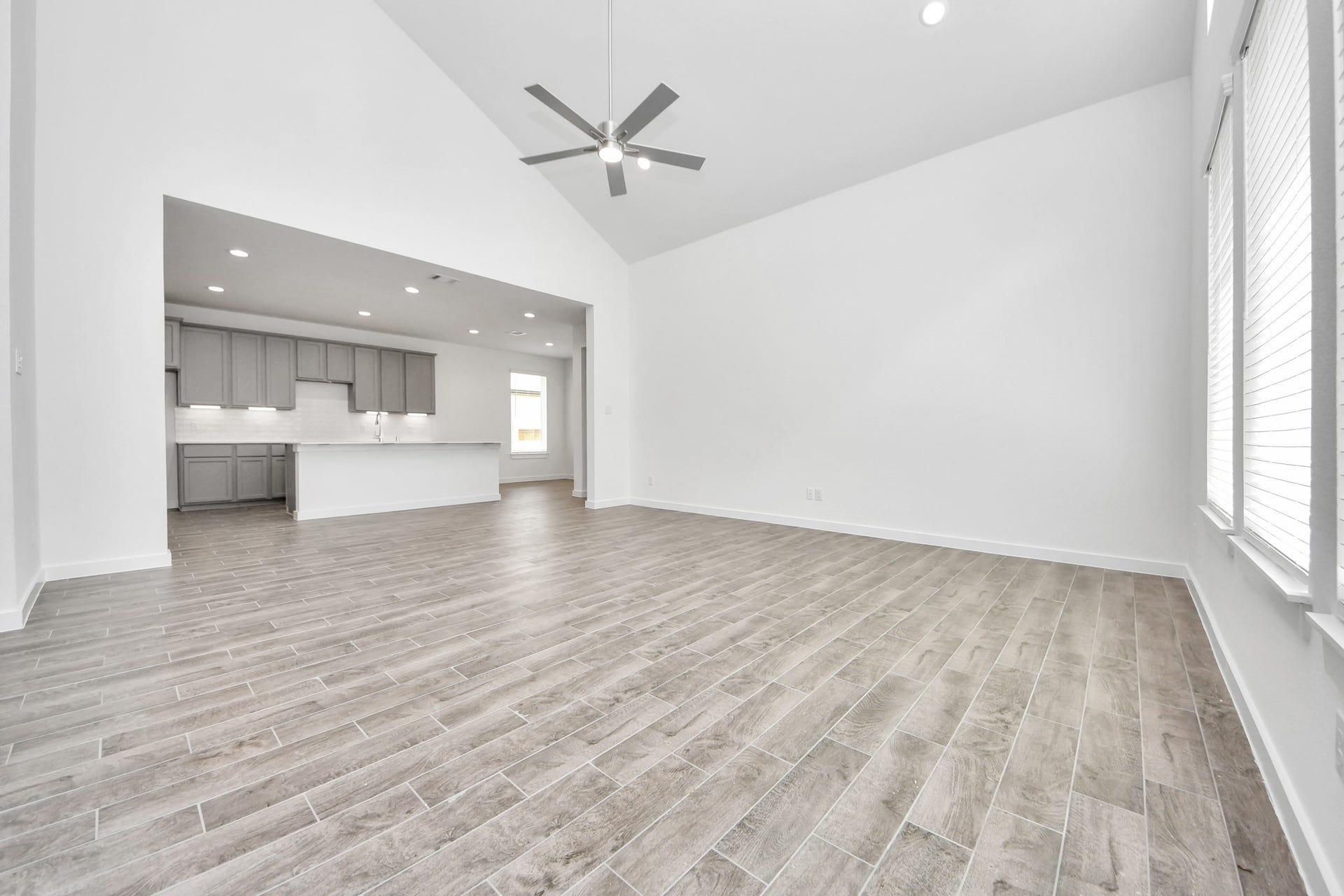 19046 Cape Capasso Drive, Hockley, TX 77447 Gather the family and guests together in your lovely living room! Featuring soaring high ceilings, recessed lighting, ceiling fan, custom paint, gorgeous floors, and large windows that provide plenty of natural lighting throughout the day. Sample photo of completed home with similar floor plan. Actual colors and selections may vary.