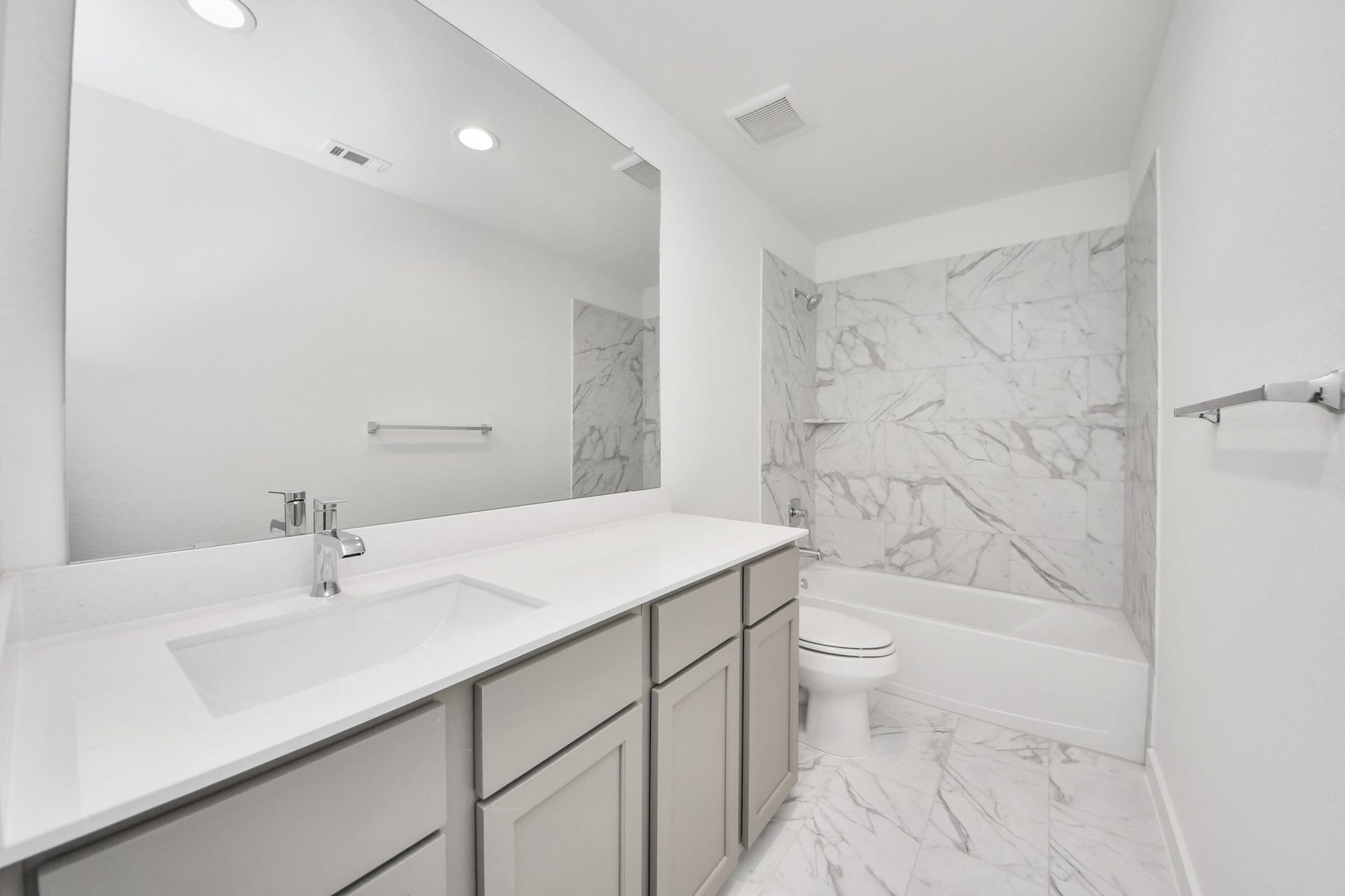 19046 Cape Capasso Drive, Hockley, TX 77447 Secondary bath features tile flooring, bath/shower combo with tile surround, light stained wood cabinets, beautiful light countertop. Sample photo of completed home with similar floor plan. Actual colors and selections may vary.