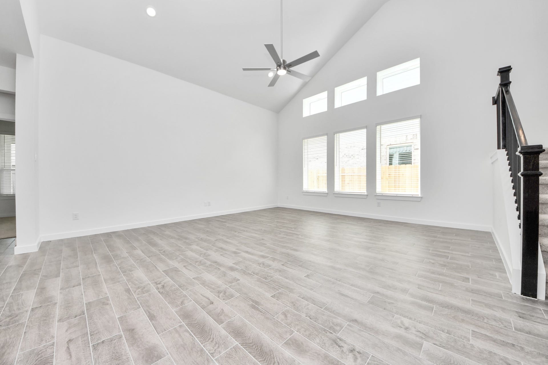 19046 Cape Capasso Drive, Hockley, TX 77447 Welcome family and guests to your charming living room! With its high ceilings, recessed lighting, ceiling fan, custom paint, beautiful flooring, and large windows that let in abundant natural light, this room is perfect for gatherings. Sample photo of completed home with similar floor plan. Actual colors and selections may vary.