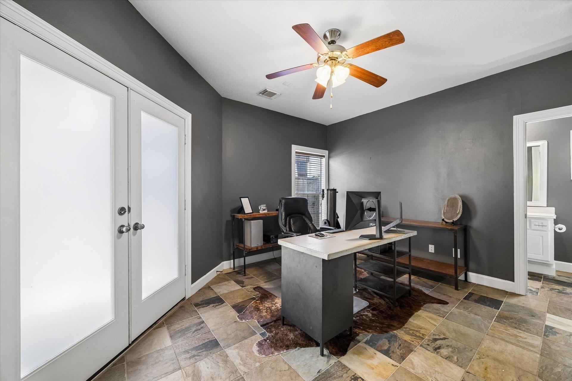 5111 Inker Street, #C, Houston, TX 77007 First floor bedroom and bathroom with slate flooring. French doors lead to a covered patio and the spacious turfed backyard.