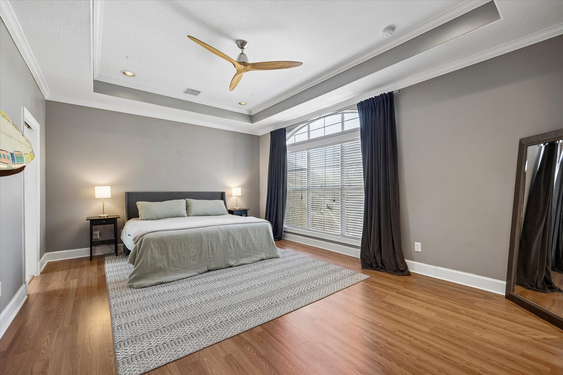 5111 Inker Street, #C, Houston, TX 77007 Very large primary bedroom is a welcome retreat with laminate wood floors, tray ceiling and large window for natural light.