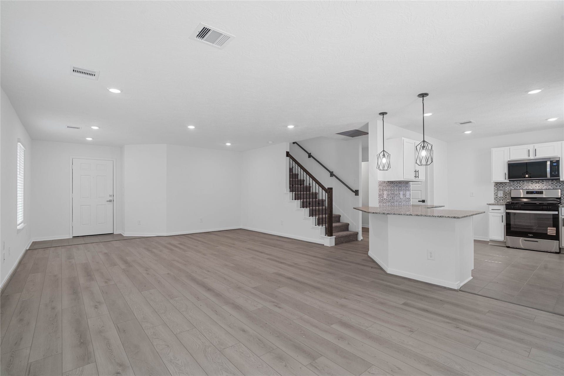 10160 Maple Cove Lane, Willis, TX 77378 Spacious open-concept design seamlessly connecting the living, dining, and kitchen areasperfect for both everyday living and entertaining!