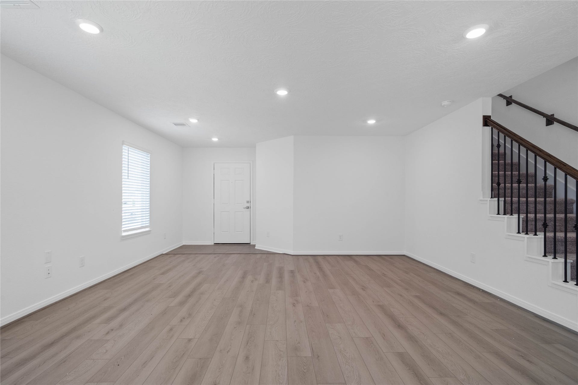 10160 Maple Cove Lane, Willis, TX 77378 This bright and airy Great Room offers a spacious layout ideal for both relaxing evenings and lively gatherings. Designed for comfort and connection, it features Layton Lake vinyl plank flooring, large window, high ceilings, recessed lighting, and seamless access to the kitchen and diningperfect for everyday living and entertaining alike.