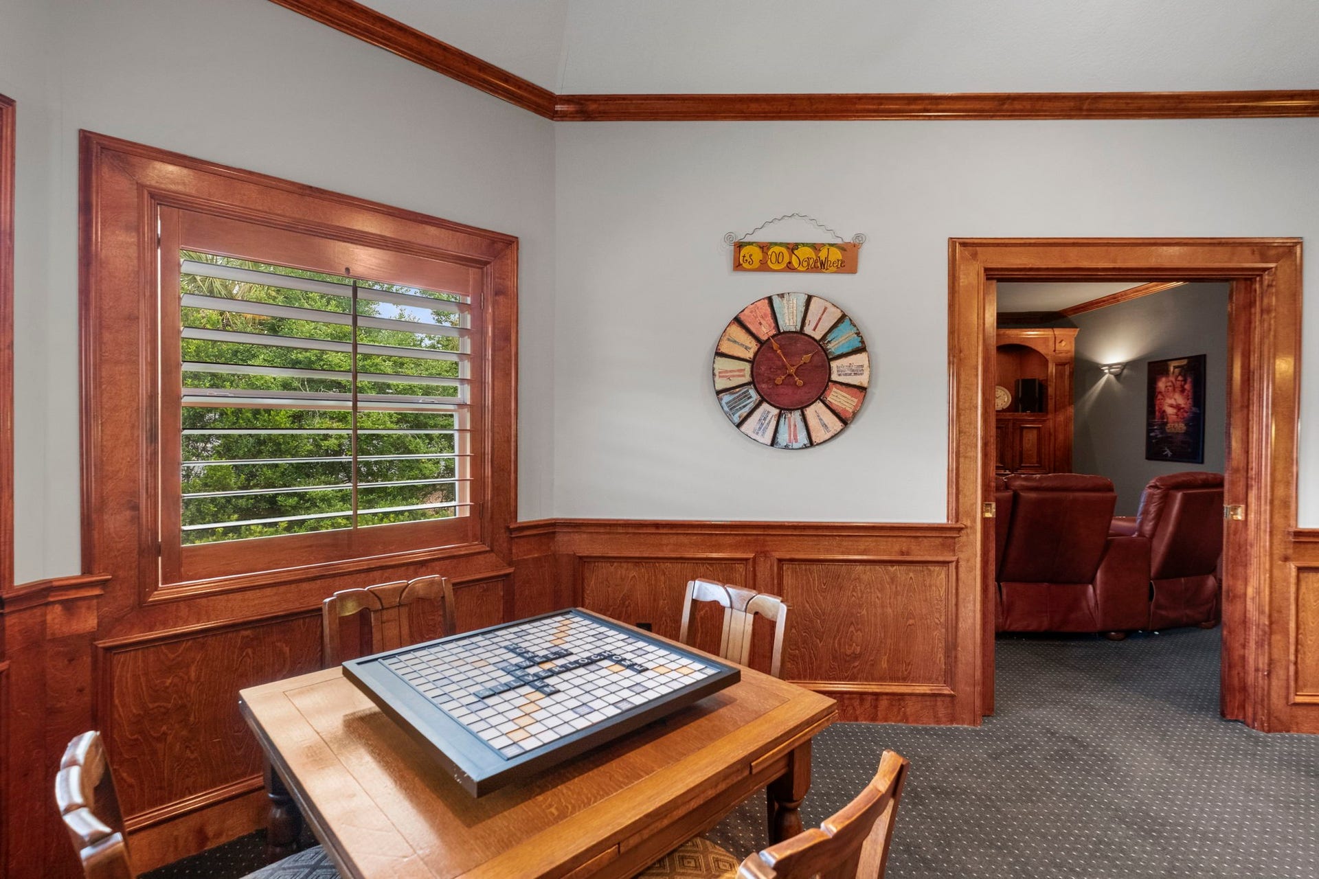 7 Silverloch Court, Sugar Land, TX 77479 Charming game room featuring rich wood paneling, a cozy table for board games, and a glimpse into a comfortable Media room