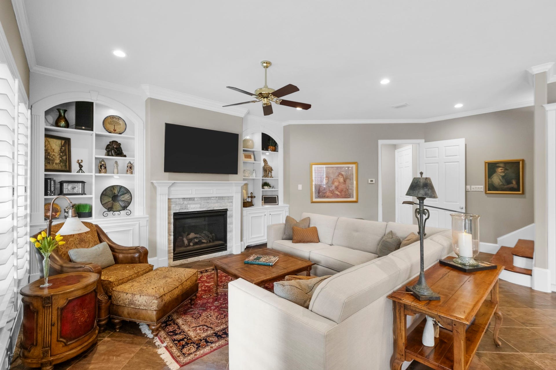 7 Silverloch Court, Sugar Land, TX 77479 Family Room featuring a cozy gas log fireplace, built-in shelves, perfect for relaxing and entertaining.