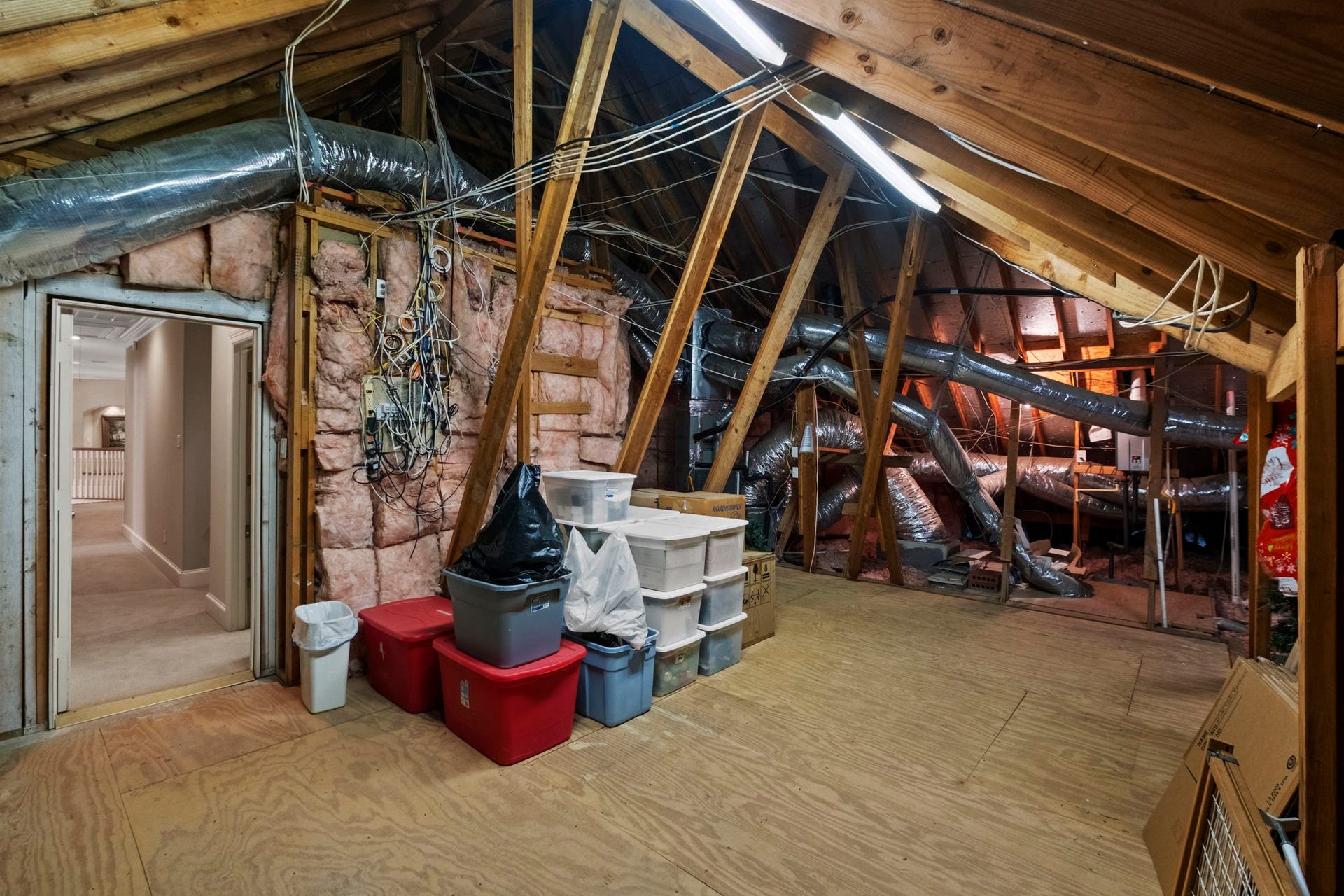 7 Silverloch Court, Sugar Land, TX 77479 Spacious walk in attic with ample storage, featuring exposed beams and ductwork, ideal for organizing seasonal items or potential 5th bedroom and bath