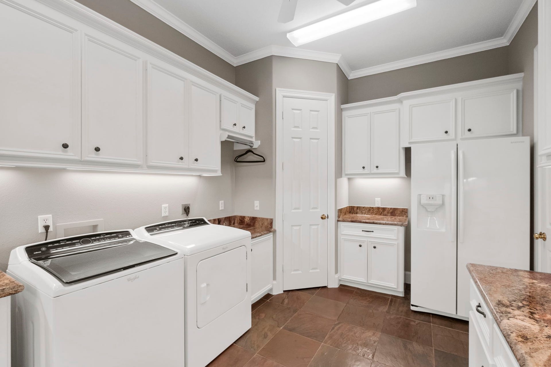 7 Silverloch Court, Sugar Land, TX 77479 Corner utility closet has ample space for all cleaning equipment and space for a 2nd Refrigerator