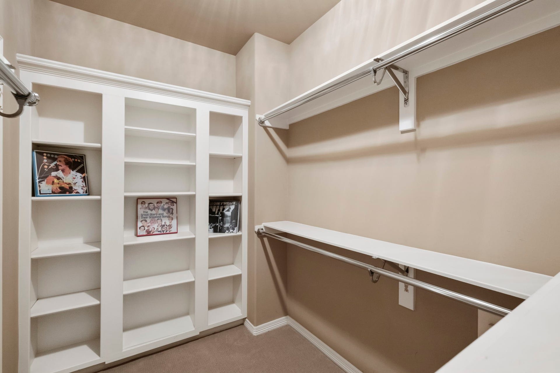7 Silverloch Court, Sugar Land, TX 77479 Spacious walk-in closet featuring built-in shelving and ample hanging space for organized storage. All closets also feature