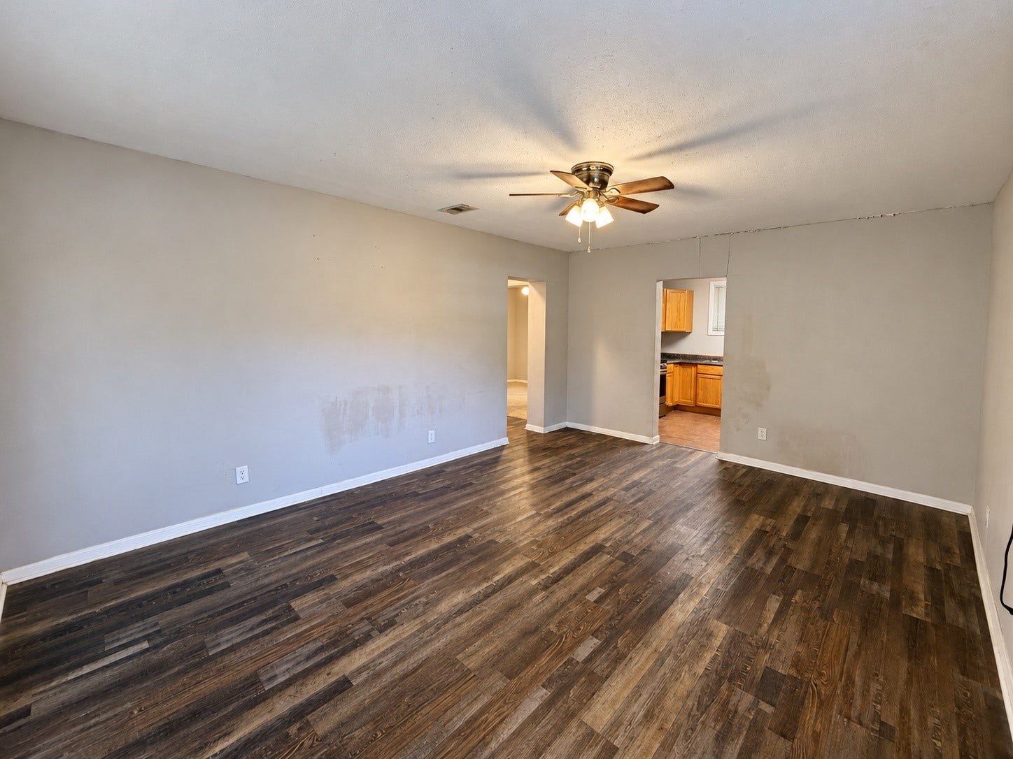 7442 Allsup Street, Houston, TX 77061 Living room (12x17) with wood-look flooring, a ceiling fan and lots of natural light.
