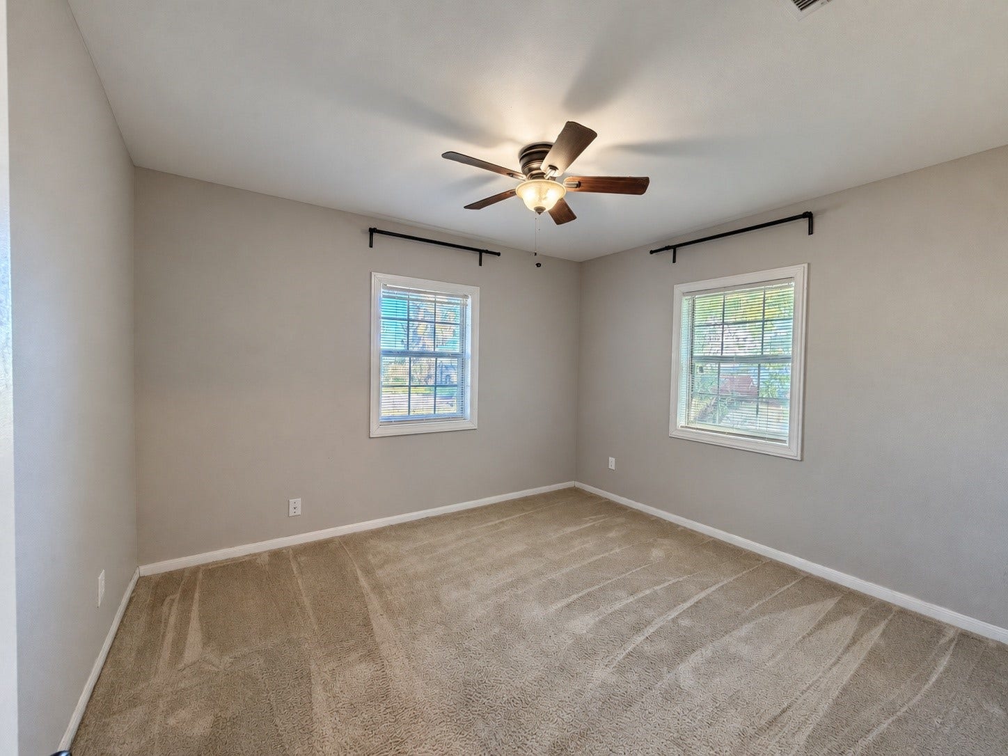 7442 Allsup Street, Houston, TX 77061 Bedroom 1 (approx. 11x12) with a ceiling fan, two windows and carpet.