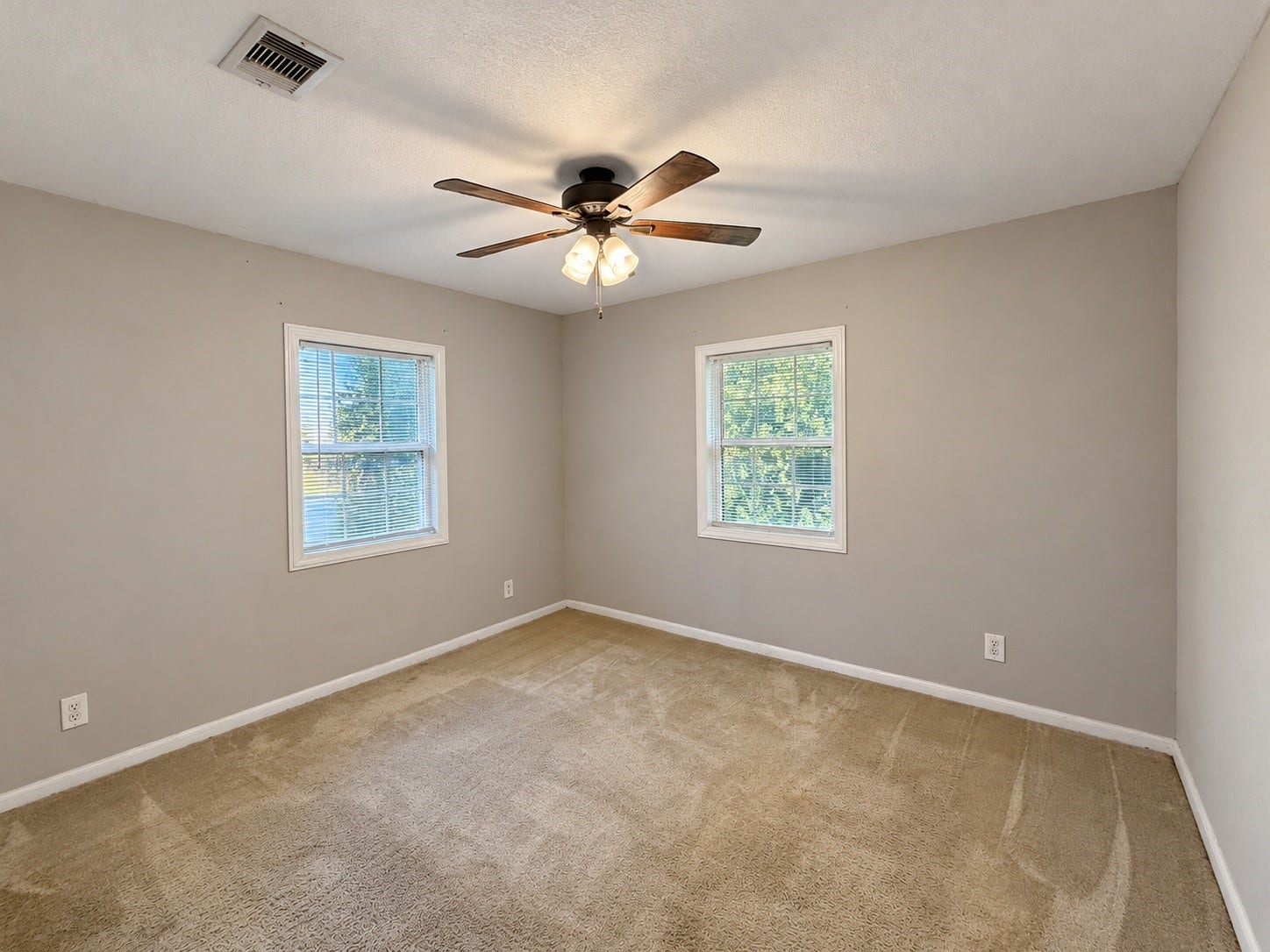7442 Allsup Street, Houston, TX 77061 Bedroom 2 (approx. 11x12) with a ceiling fan and two windows.