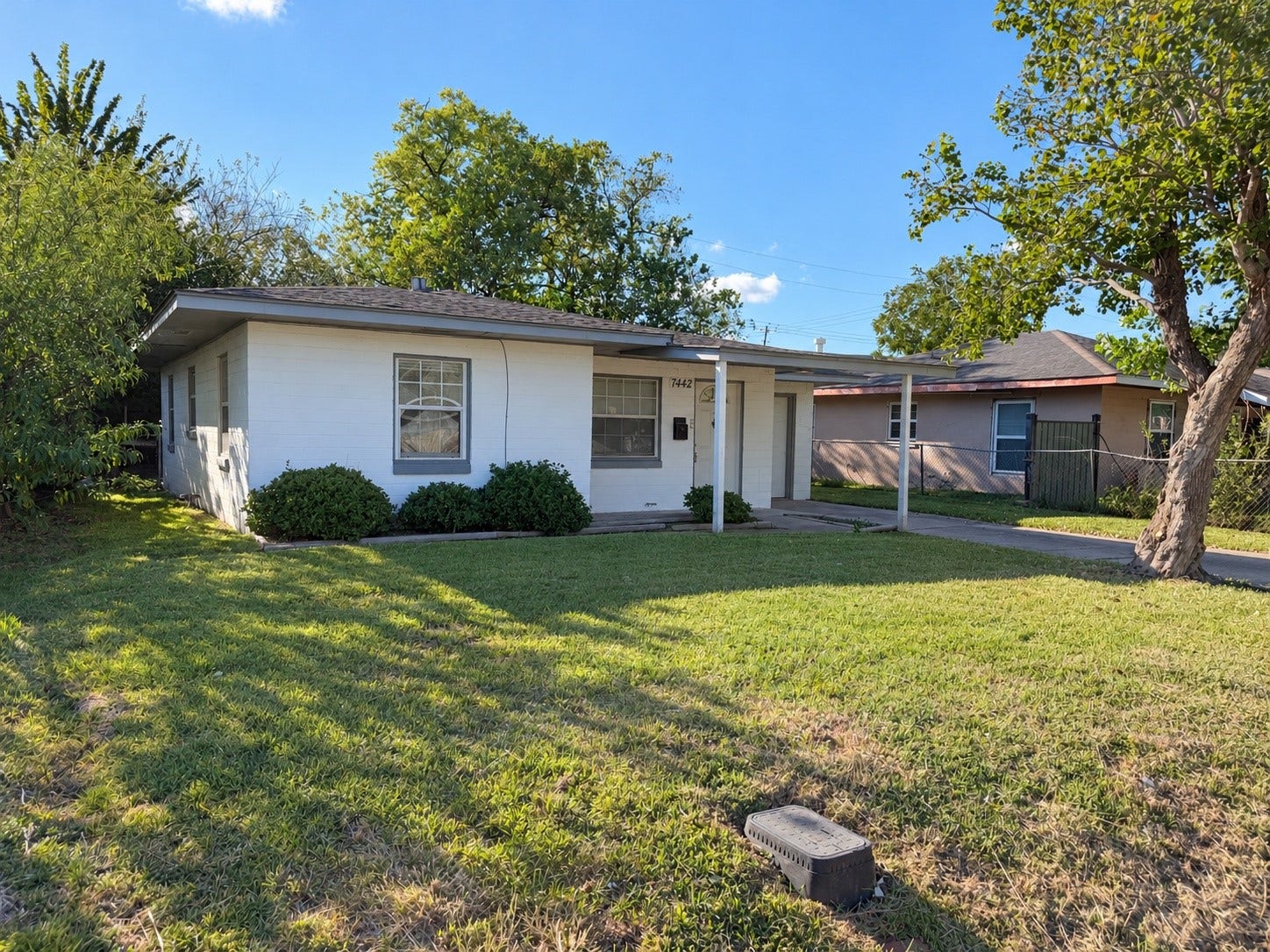 7442 Allsup Street, Houston, TX 77061 Front yard with plenty of green space and mature trees.