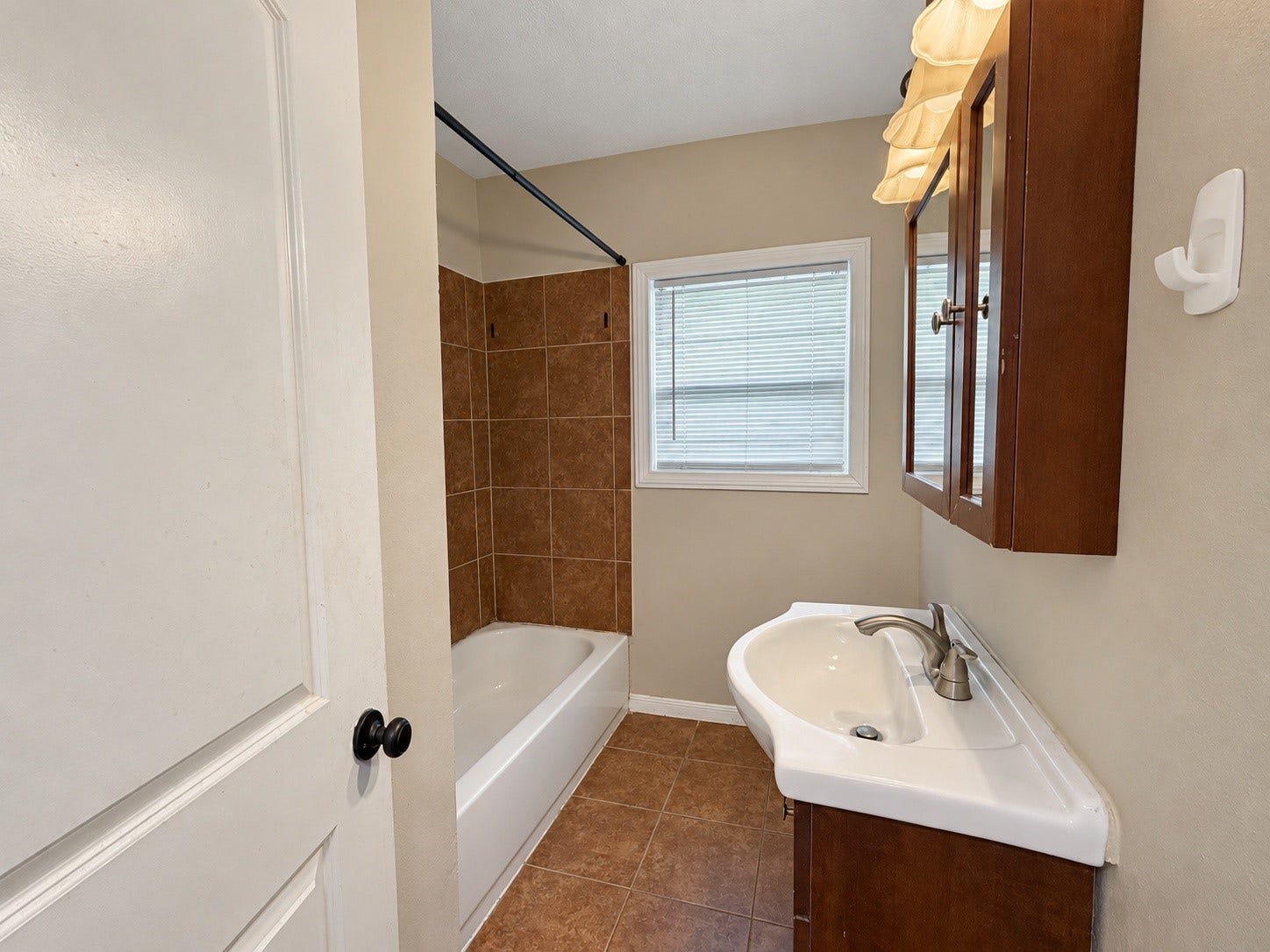 7442 Allsup Street, Houston, TX 77061 Bathroom vanity with storage and a window for natural light.