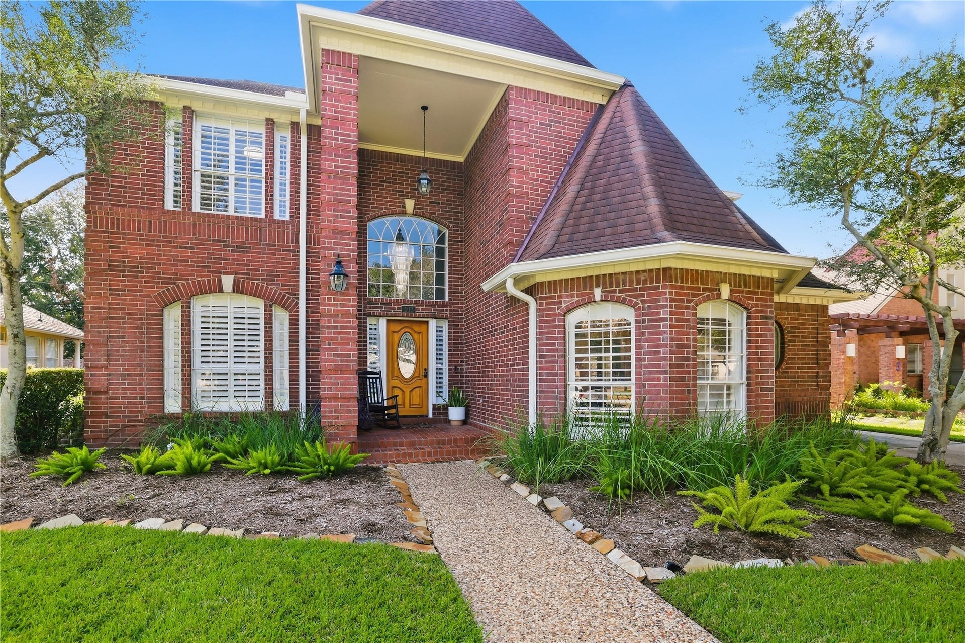 Stunning architectural details include arched windows, distinctive rooflines, a dramatic two-story entry window, and classic brickwork.