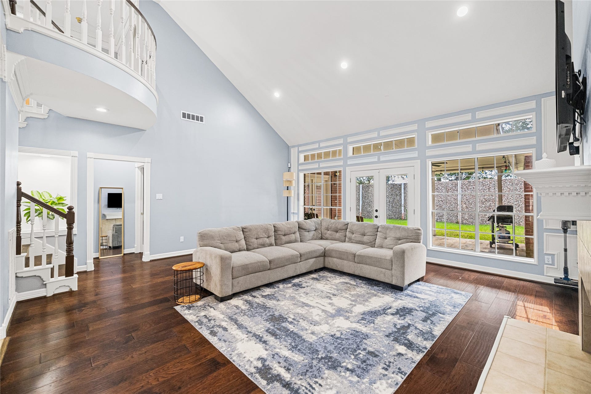Beautiful wall of windows fills the spacious family room with natural light, offering views of the backyard and access to the covered patio.
