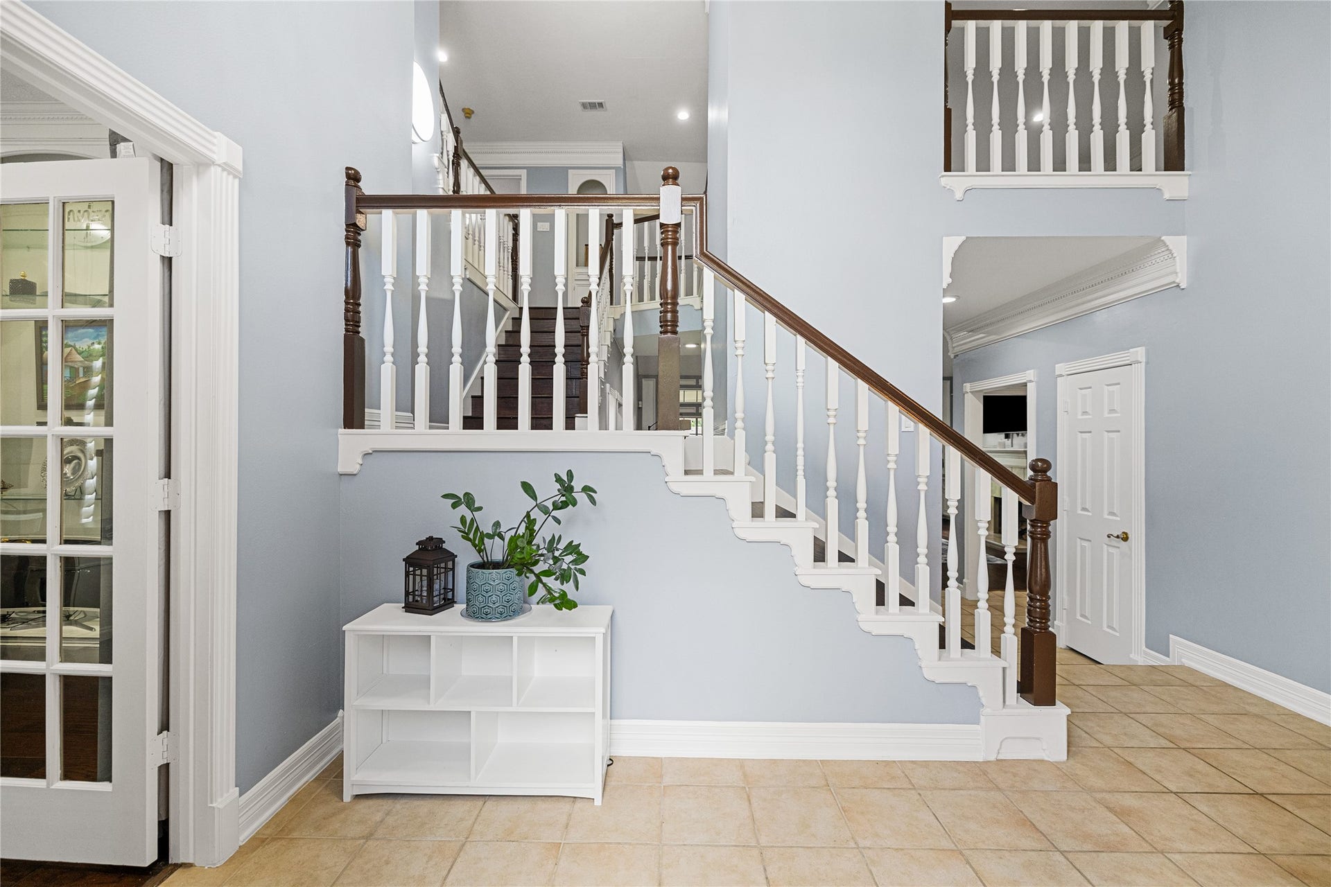 Beautiful staircase featuring rich wood treads, contrasting white balusters, and elegant architectural details connecting the home's two levels.