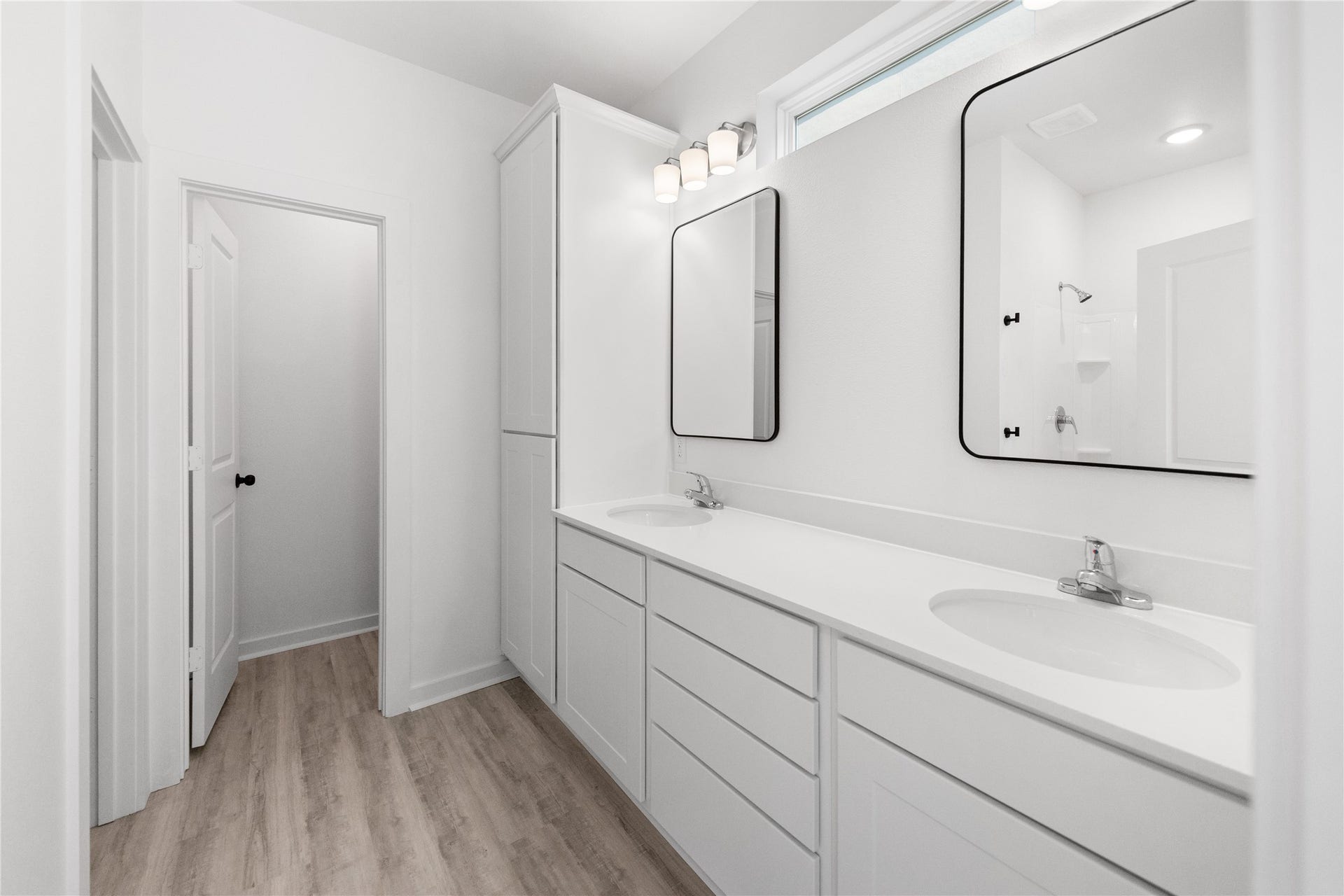 3326 Anita, #B, Houston, TX 77004 Primary bathroom with two vanity sinks and tasteful blk accent lighting