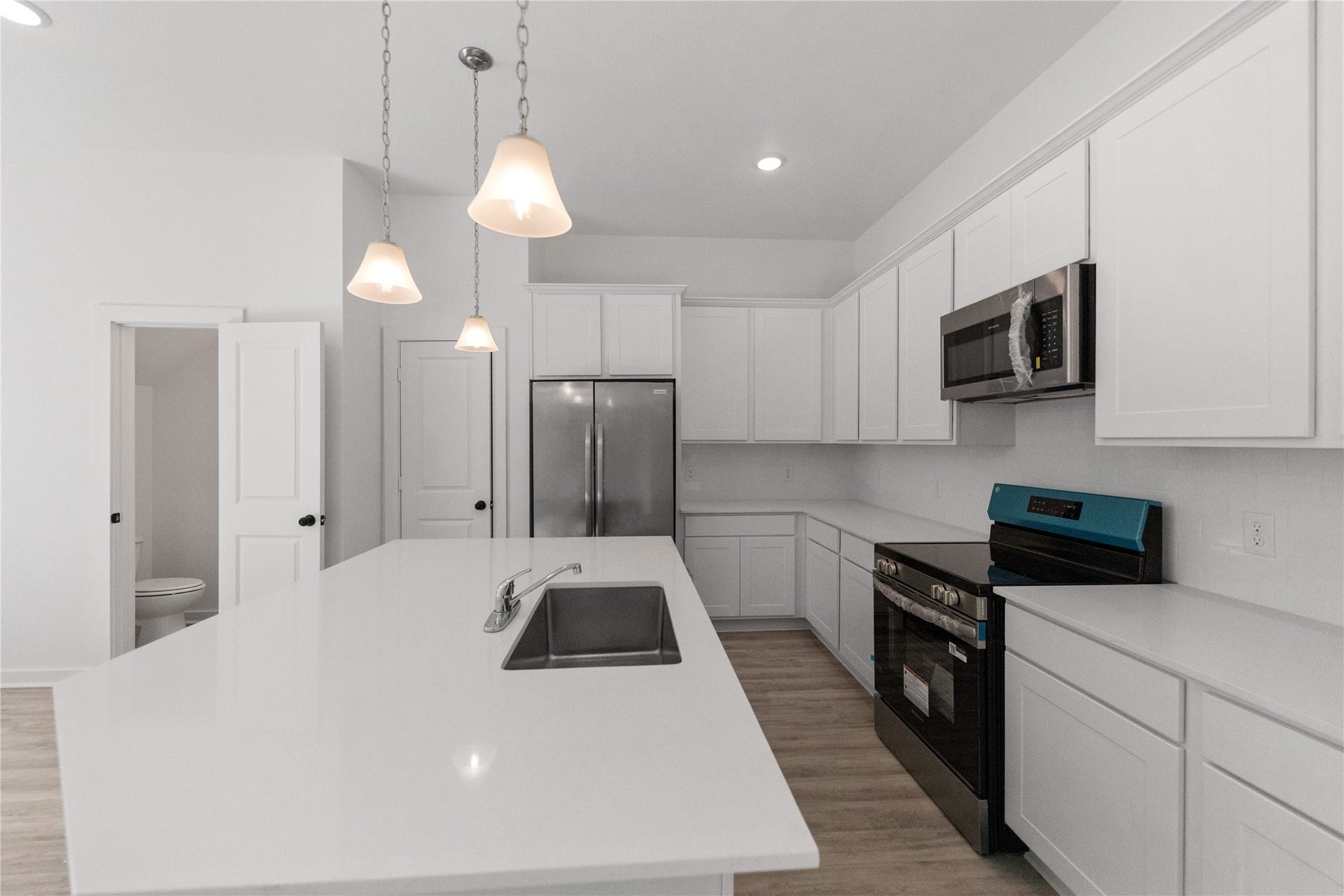 3326 Anita, #B, Houston, TX 77004 Stainless steel appliances and tasteful pendant lighting over isalnd