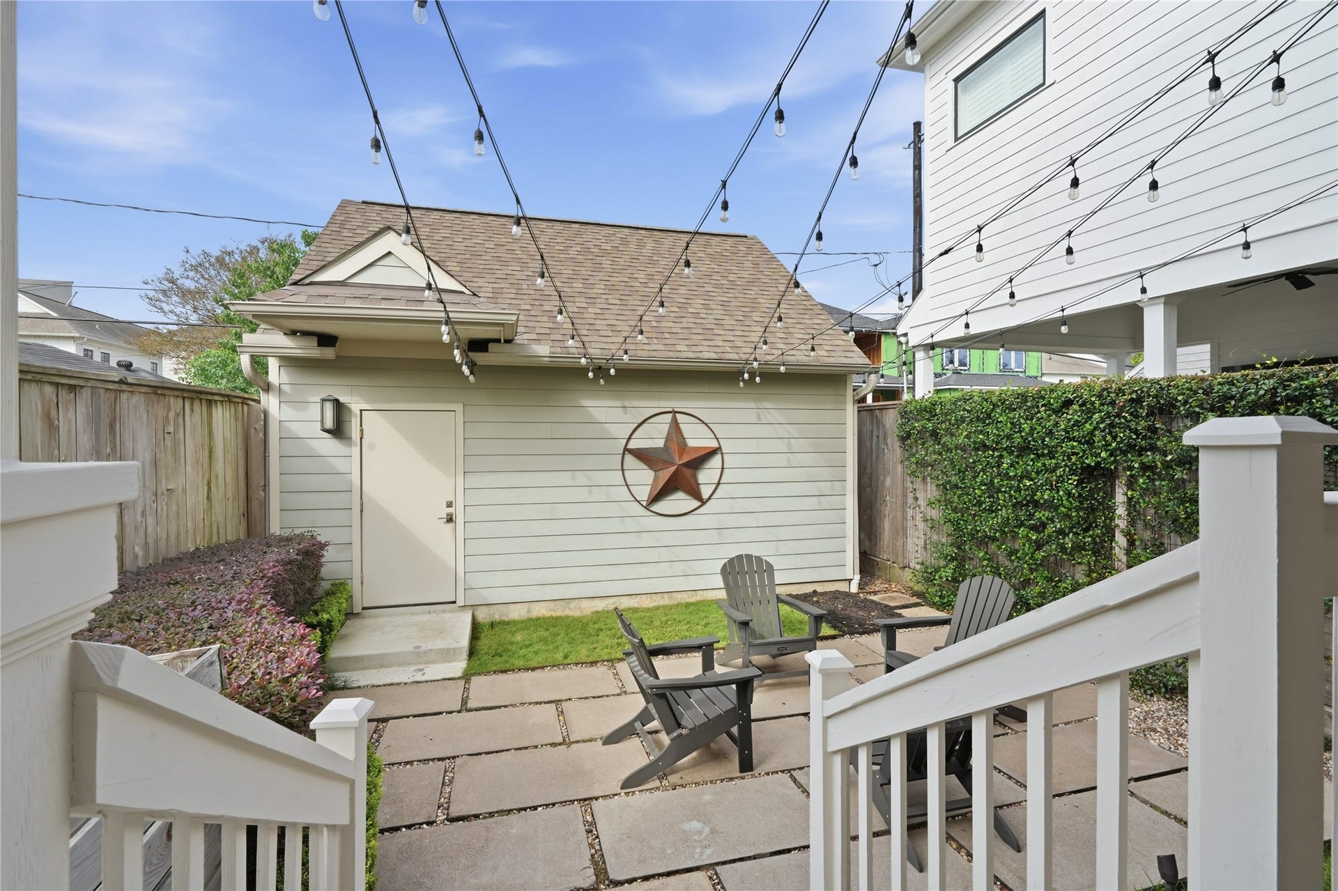 813 Ashland Street, Houston, TX 77007 Enjoy outdoor living on the charming patio, complete with caf lighting, gathering space, and direct access to the detached two-car garage.