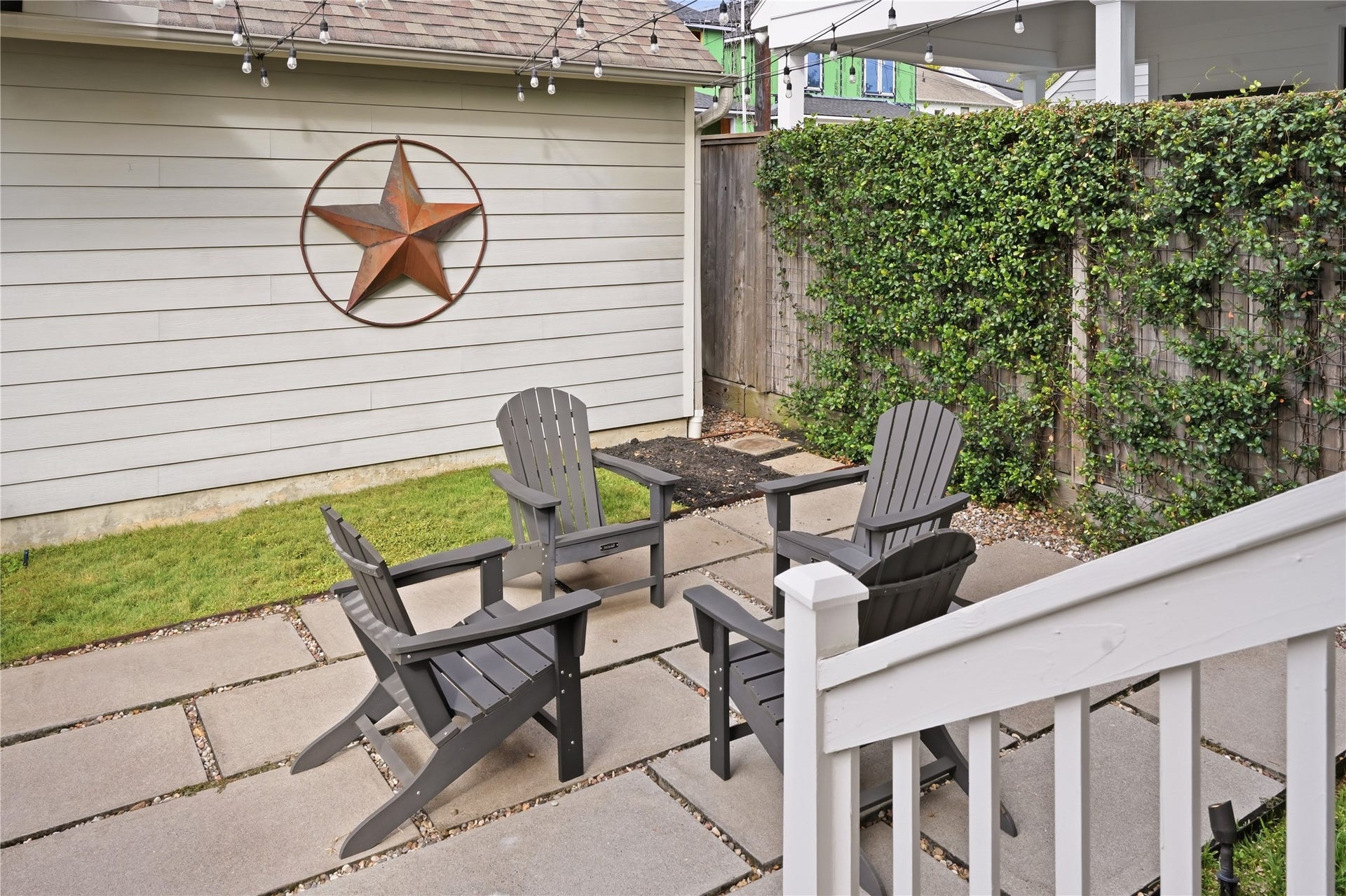 813 Ashland Street, Houston, TX 77007 The charming backyard retreat features a spacious patio, caf lighting, and ample room for entertaining or unwinding outdoors.