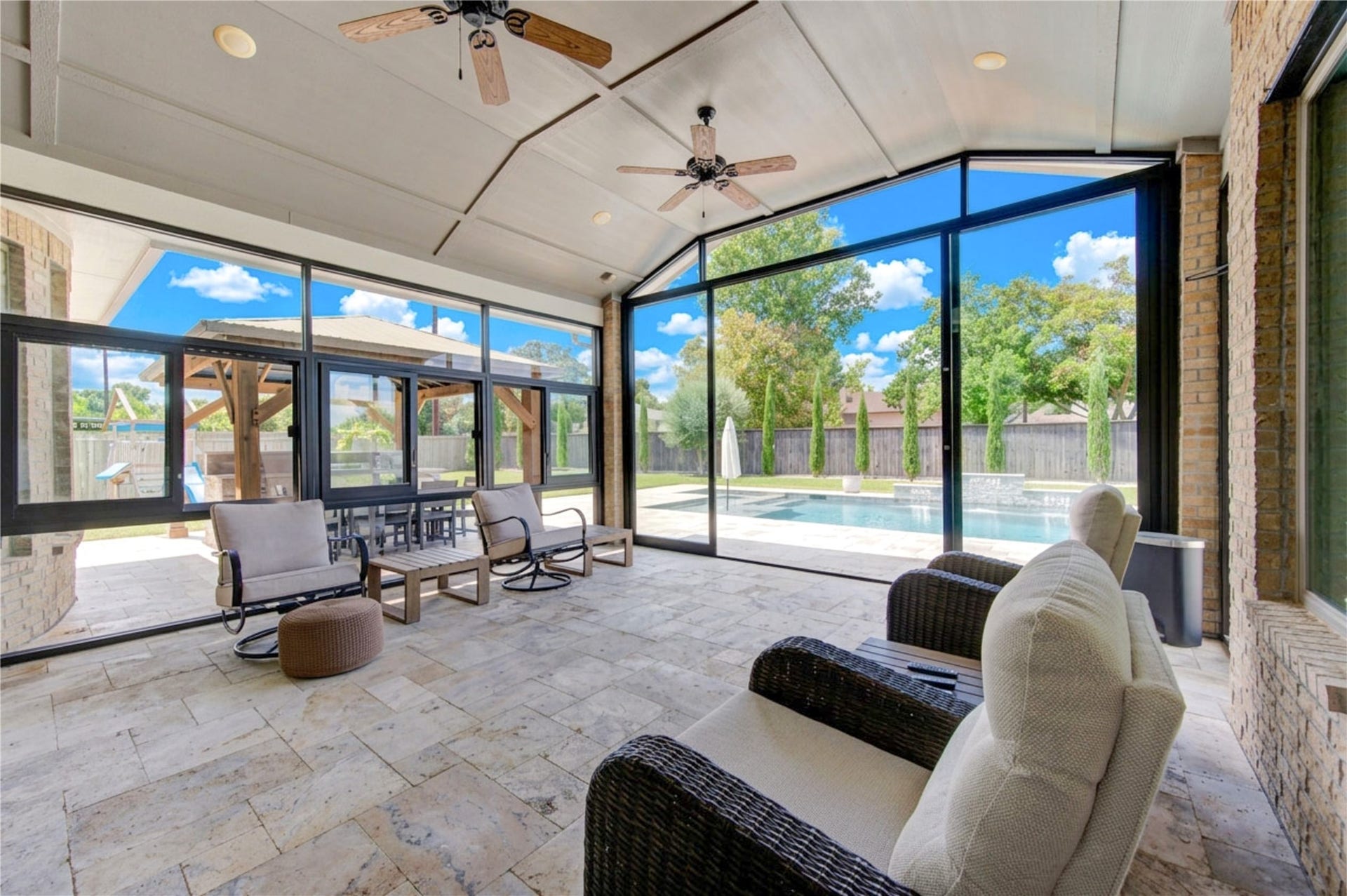 2803 Enriched Enclave Court, Richmond, TX 77406 Spacious screened-in patio with soaring ceilings and beautiful pool viewsideal for comfortable year-round outdoor living.