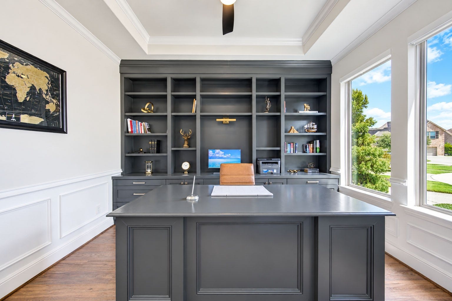 2803 Enriched Enclave Court, Richmond, TX 77406 Sophisticated private study featuring custom built-in cabinetry, a spacious executive desk, tray ceiling, and abundant natural light.