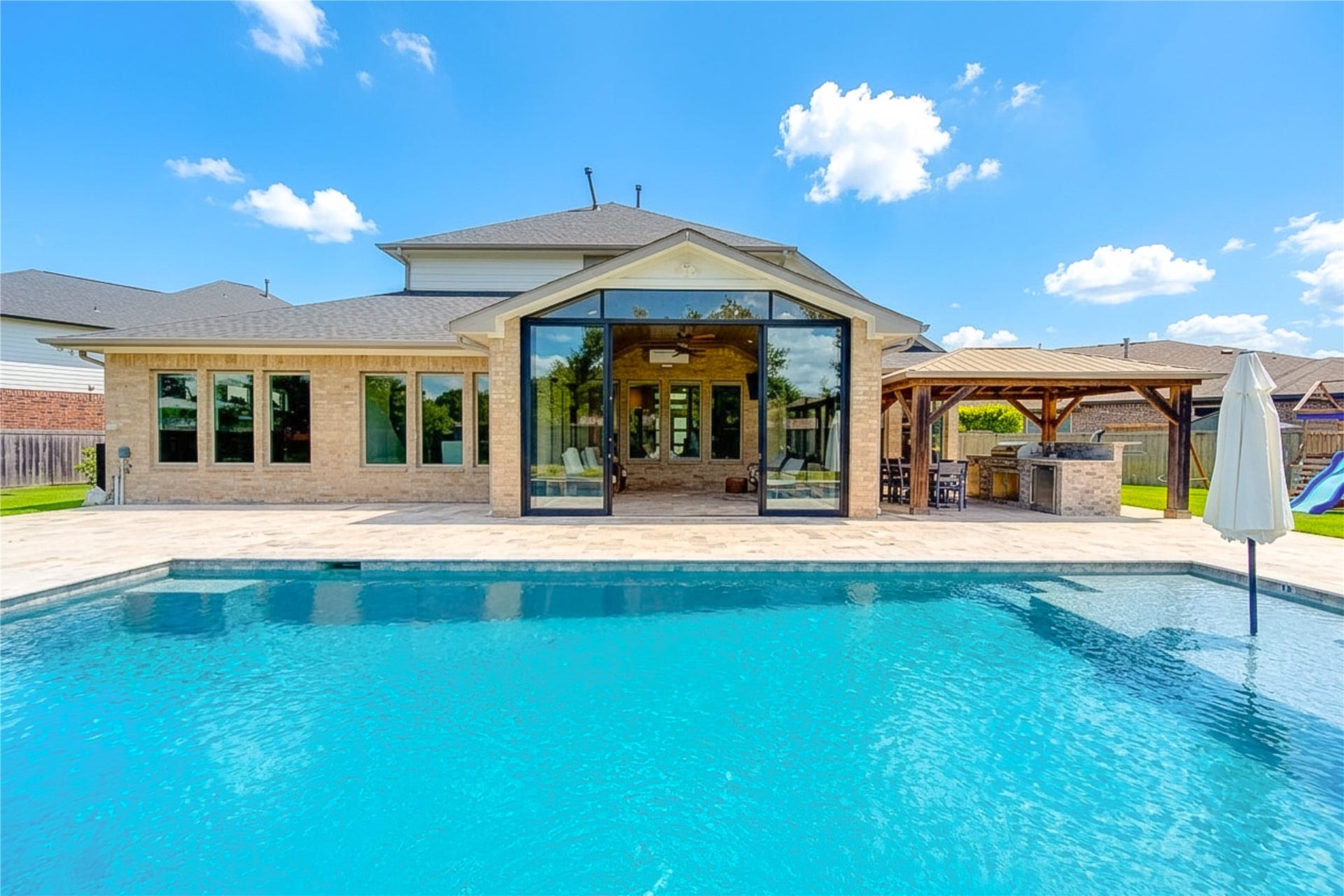 2803 Enriched Enclave Court, Richmond, TX 77406 Resort-style salt water pool framed by an expansive patio, enclosed sunroom, and covered outdoor kitchendesigned for year-round enjoyment. Pool has a heater and a chiller pump!