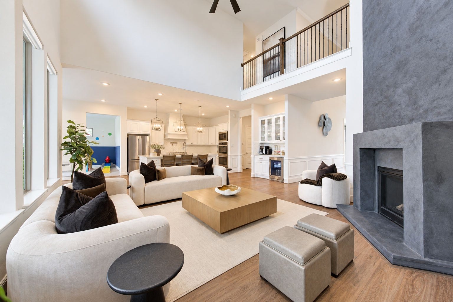 2803 Enriched Enclave Court, Richmond, TX 77406 Stunning open-concept design seamlessly connects the kitchen and living area beneath soaring ceilings and dramatic architectural details.