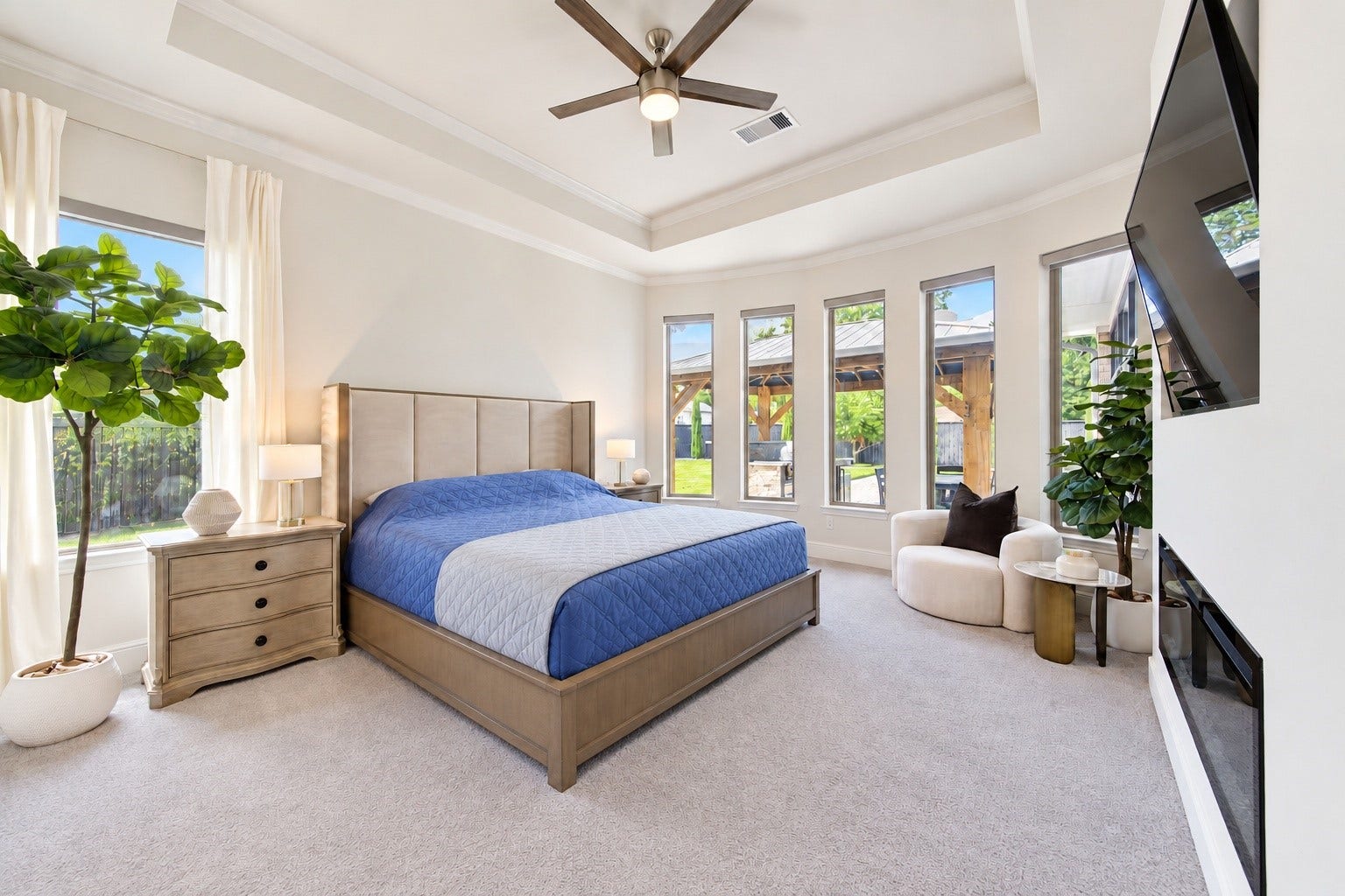 2803 Enriched Enclave Court, Richmond, TX 77406 Spacious and serene primary retreat with a tray ceiling, abundant natural light, and beautiful views of the backyard and pool.