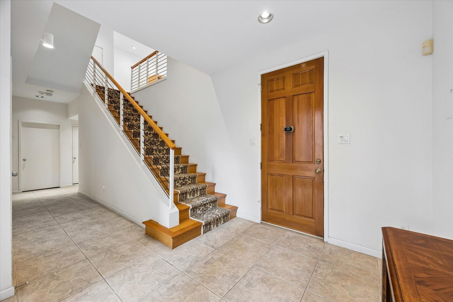UPSTAIRS TO THE BEAUTIFUL LIVING AREA.  THE CONVENIENT ELEVATOR IS RIGHT BEHIND THE STAIRCASE.
