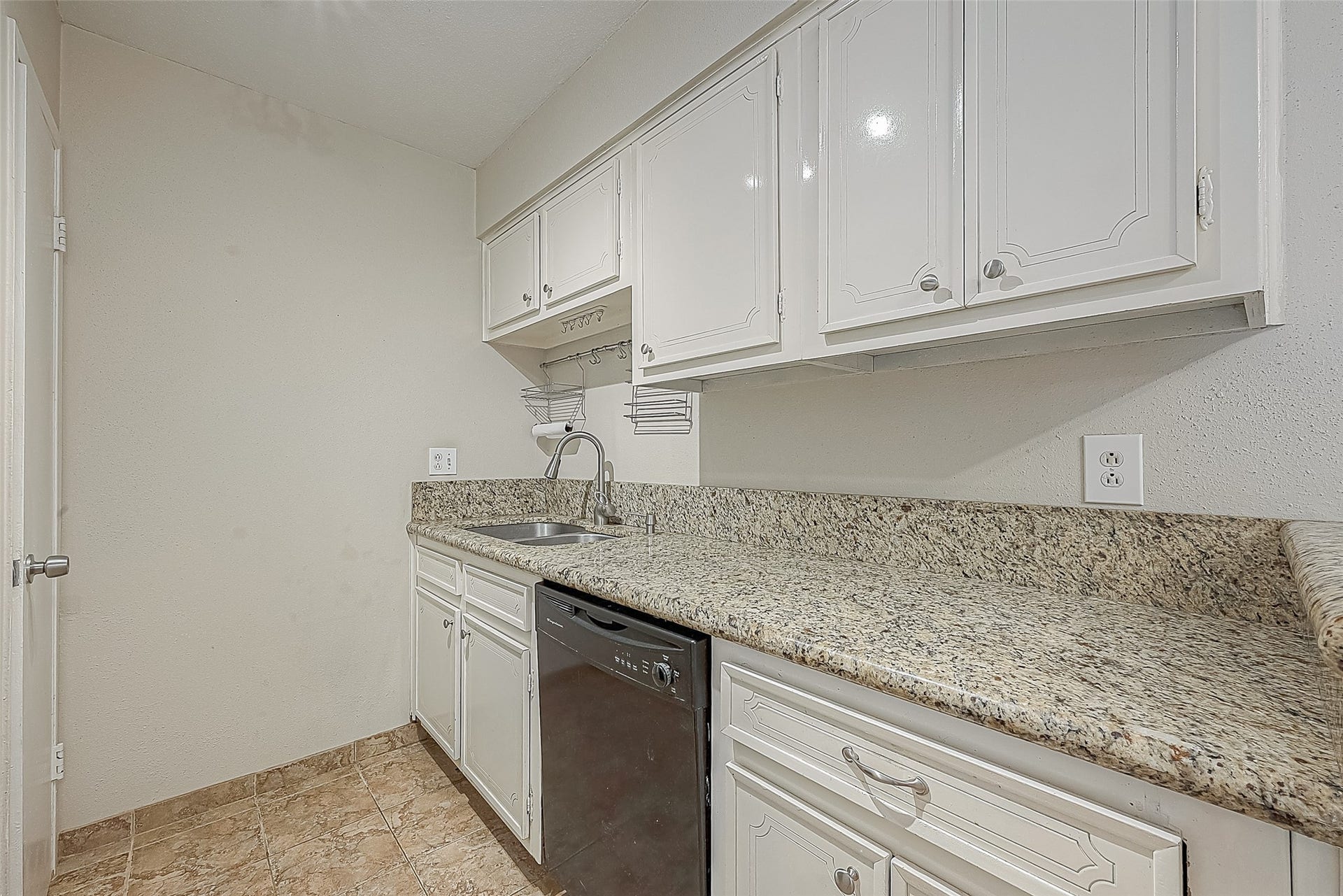 3131 Cummins Street, #54, Houston, TX 77027 Granite countertops provide plenty of prep space, while white cabinetry offers storage above & below. Kitchen also features a double stainless steel sink & dishwashermaking meal prep and clean-up a breeze!