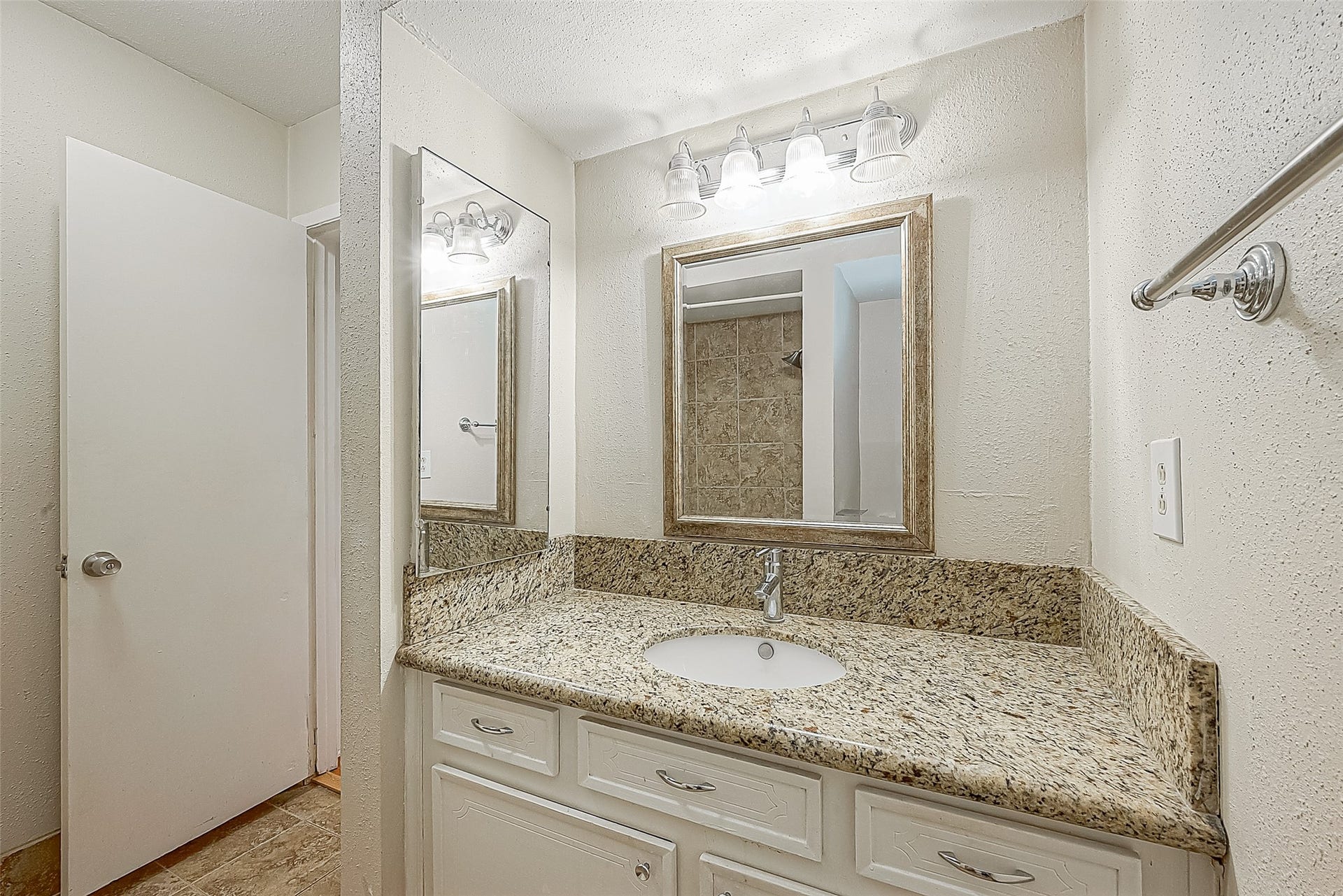 3131 Cummins Street, #54, Houston, TX 77027 Bath measures 7.11 x 6.9 and features a granite-topped vanity with updated faucet, framed mirror & updated lighting. Just outside the bath is a hallway linen closetanother convenient spot for towels, linens & everyday essentials.