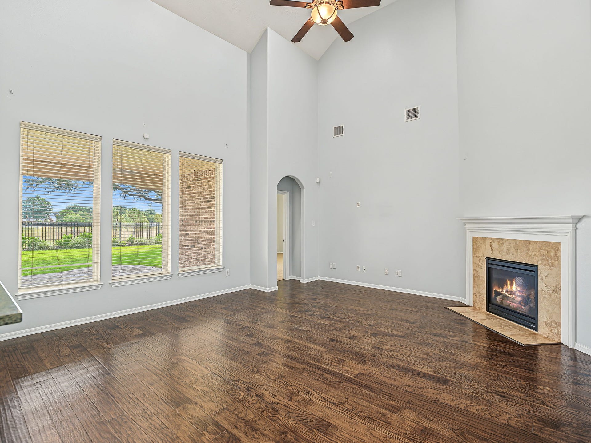 Large windows bring lots of natural light! The Primary bedroom is just thru that archway, tucked away for privacy.