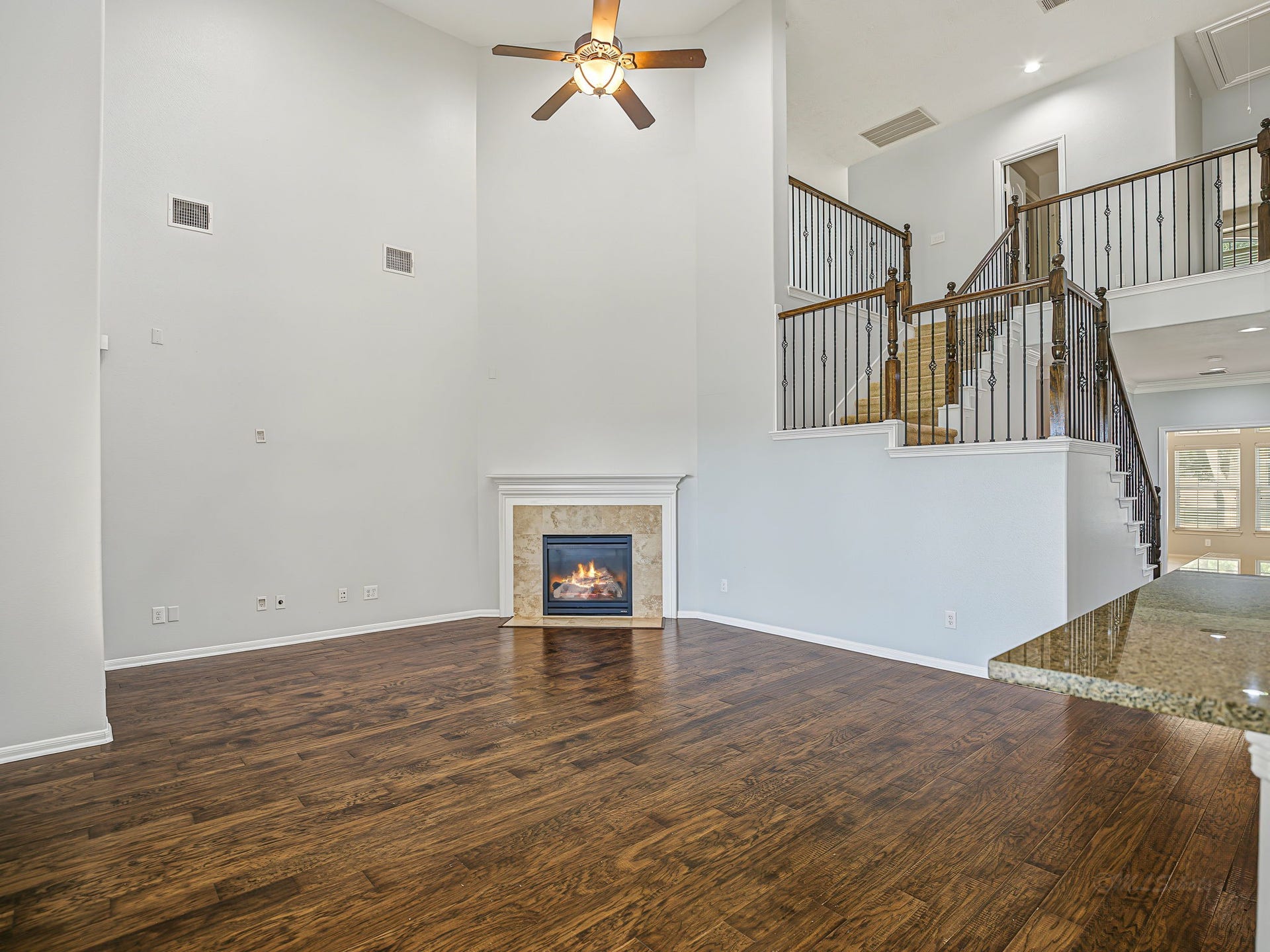 Gorgeous, 2 story family room! See how you could set it up with that fireplace as the center piece! How about that dramatic staircase!