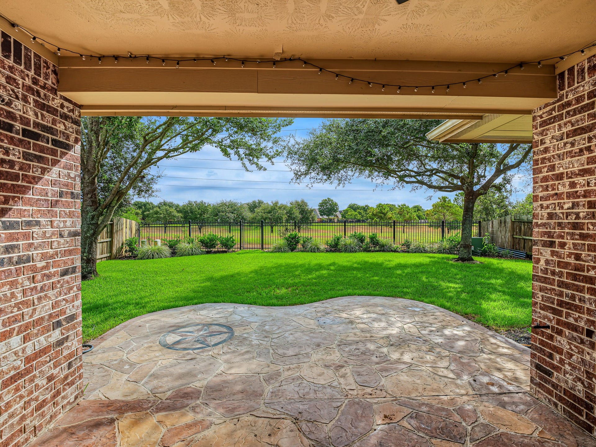 Extended, stamped cement, covered patio! No back neighbors! Green and a large pond (small lake?) beyond!