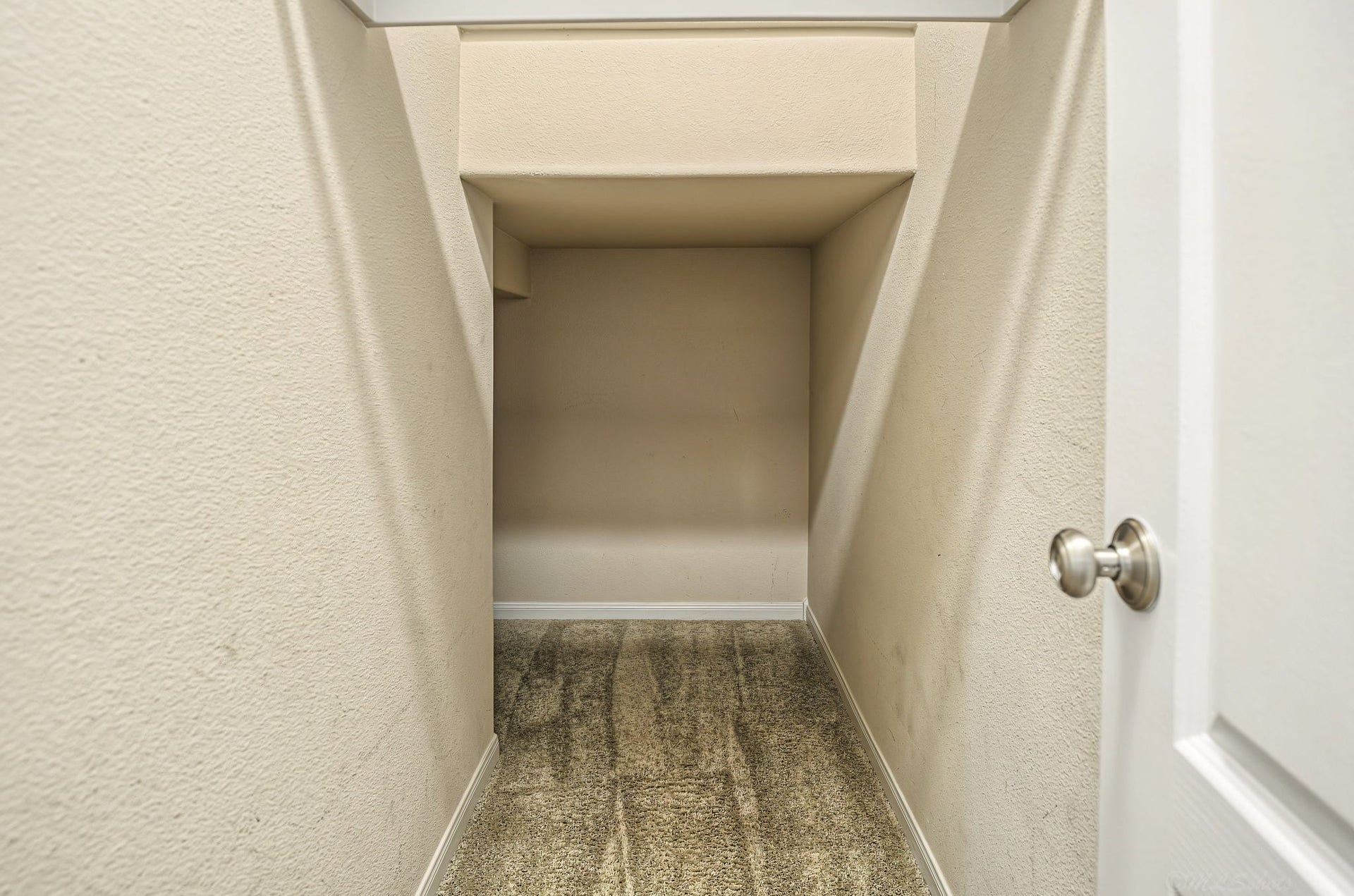 Storage closet that wraps around under the staircase!