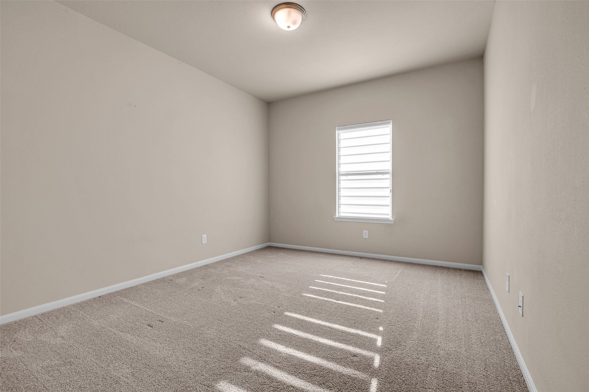 2718 Newbury Island Lane, Katy, TX 77493 One of the second-floor secondary bedrooms features a carpeted floor and a bright, welcoming atmosphere.