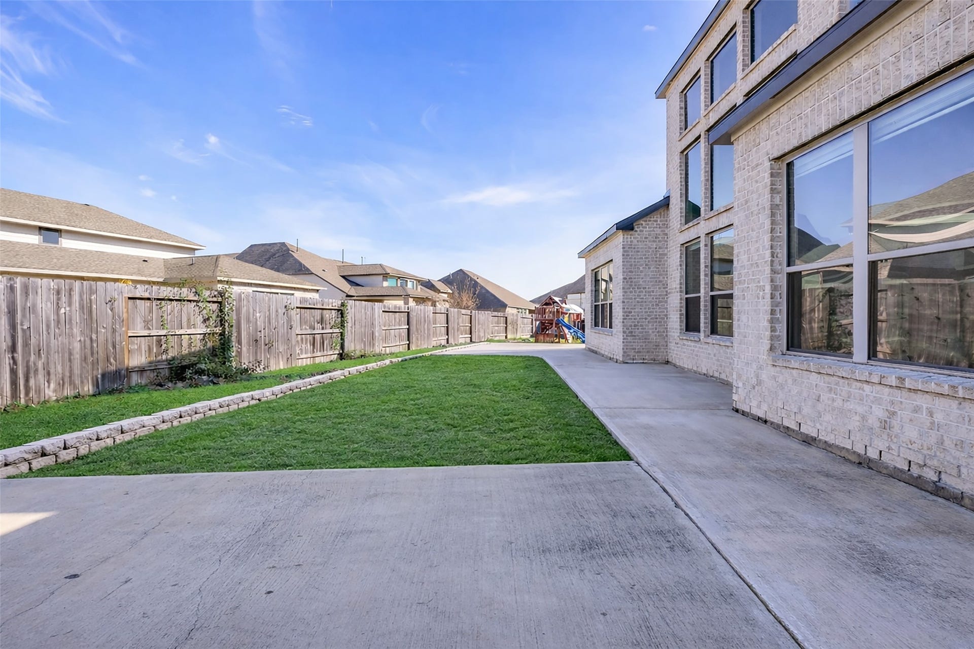 2718 Newbury Island Lane, Katy, TX 77493 The backyard is partly paved and partly grass-covered, fully enclosed for privacy and usability.