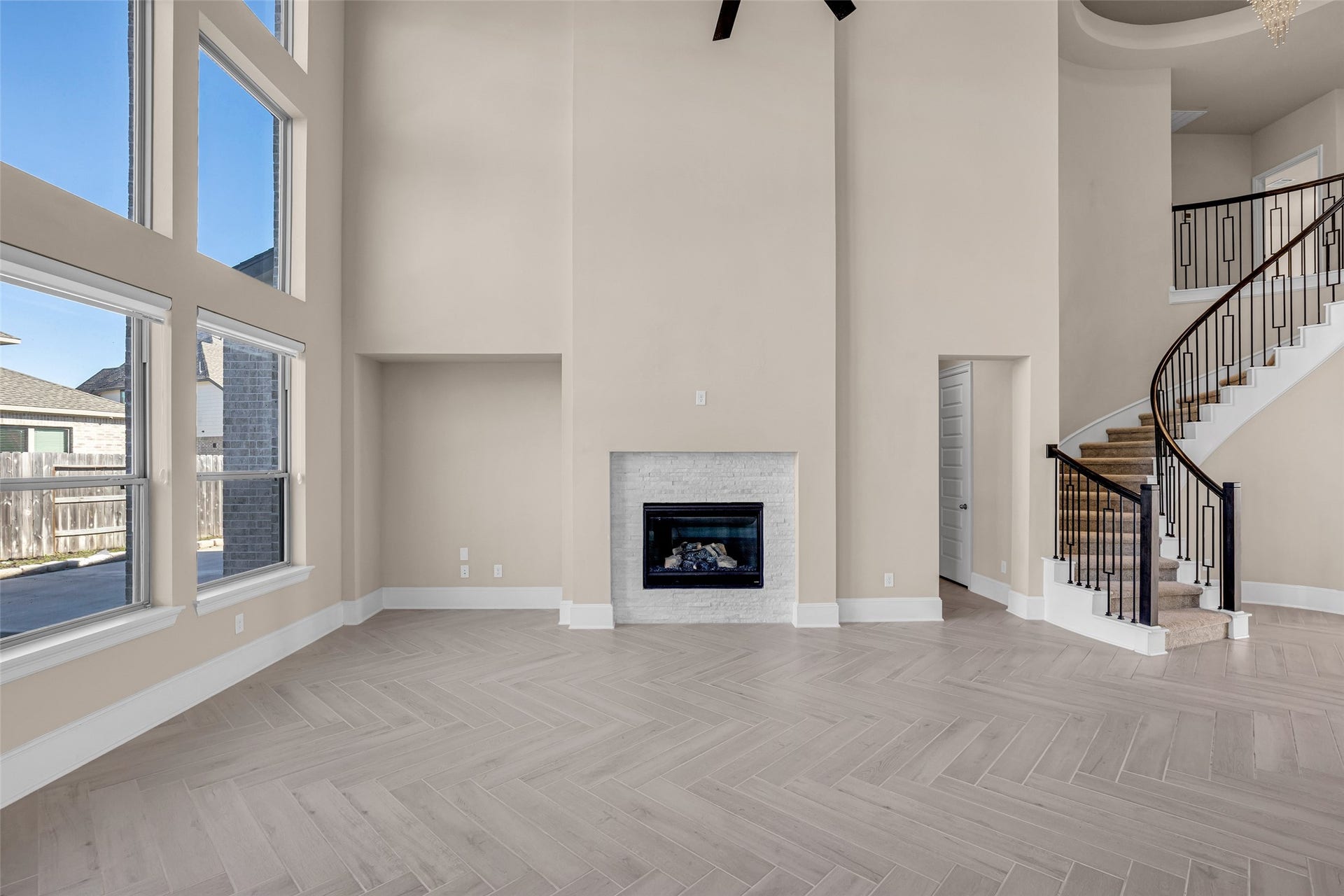 2718 Newbury Island Lane, Katy, TX 77493 The room features a fireplace and high ceilings, adding character and a sense of openness.