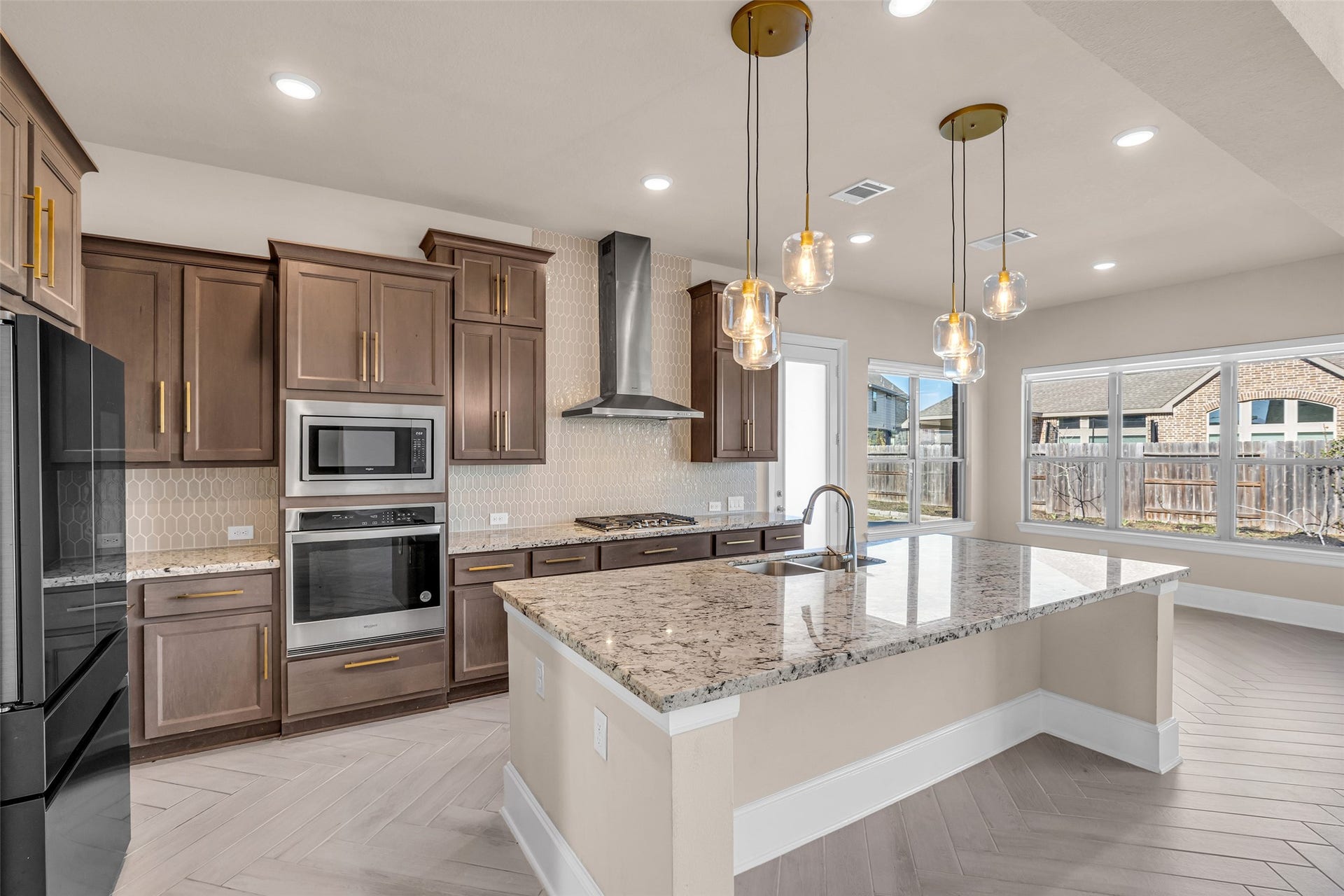 2718 Newbury Island Lane, Katy, TX 77493 The kitchen includes an oversized island with a sink, which can also serve as a breakfast bar.