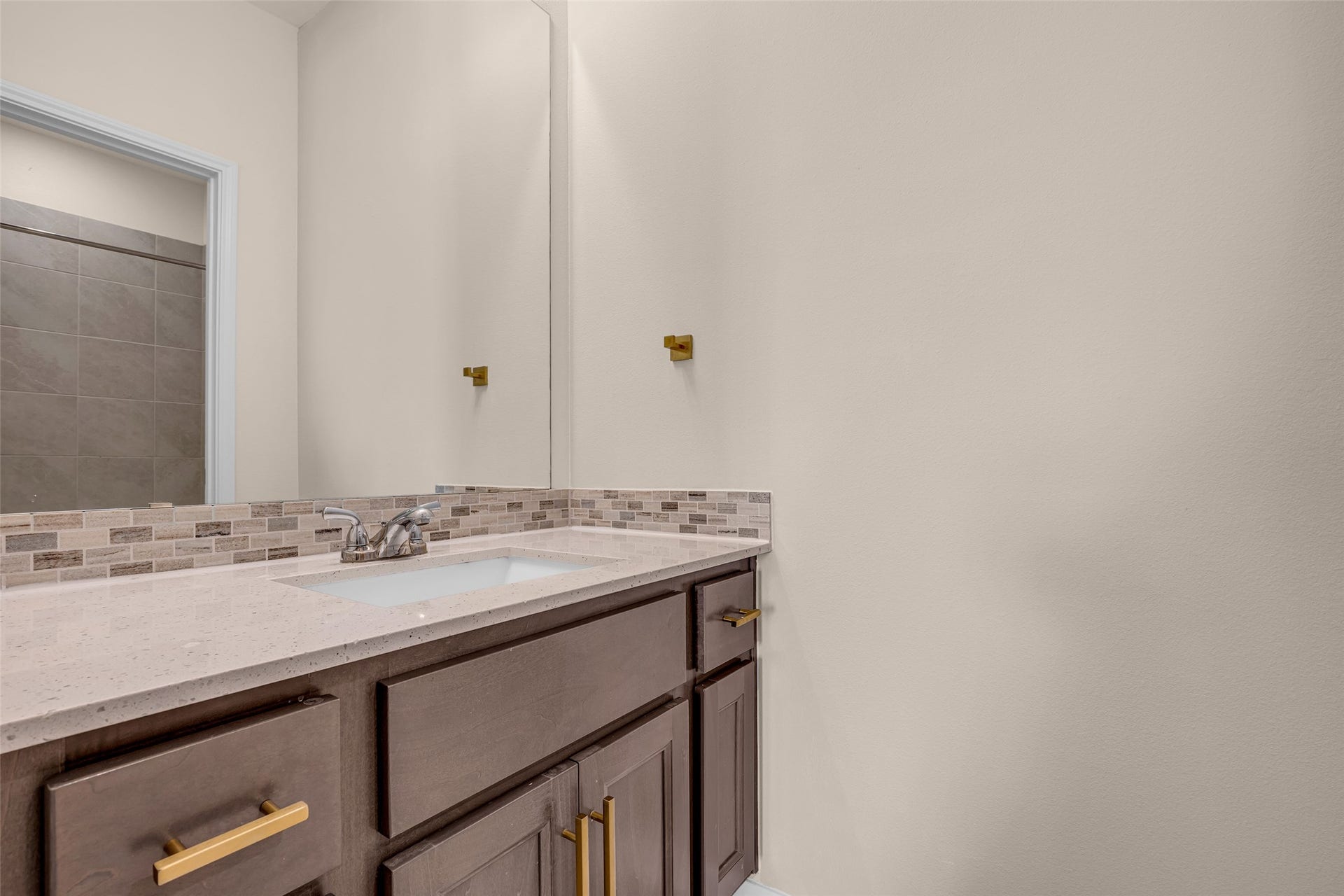 2718 Newbury Island Lane, Katy, TX 77493 This bedroom includes a private bathroom with modern fixtures and finishes.