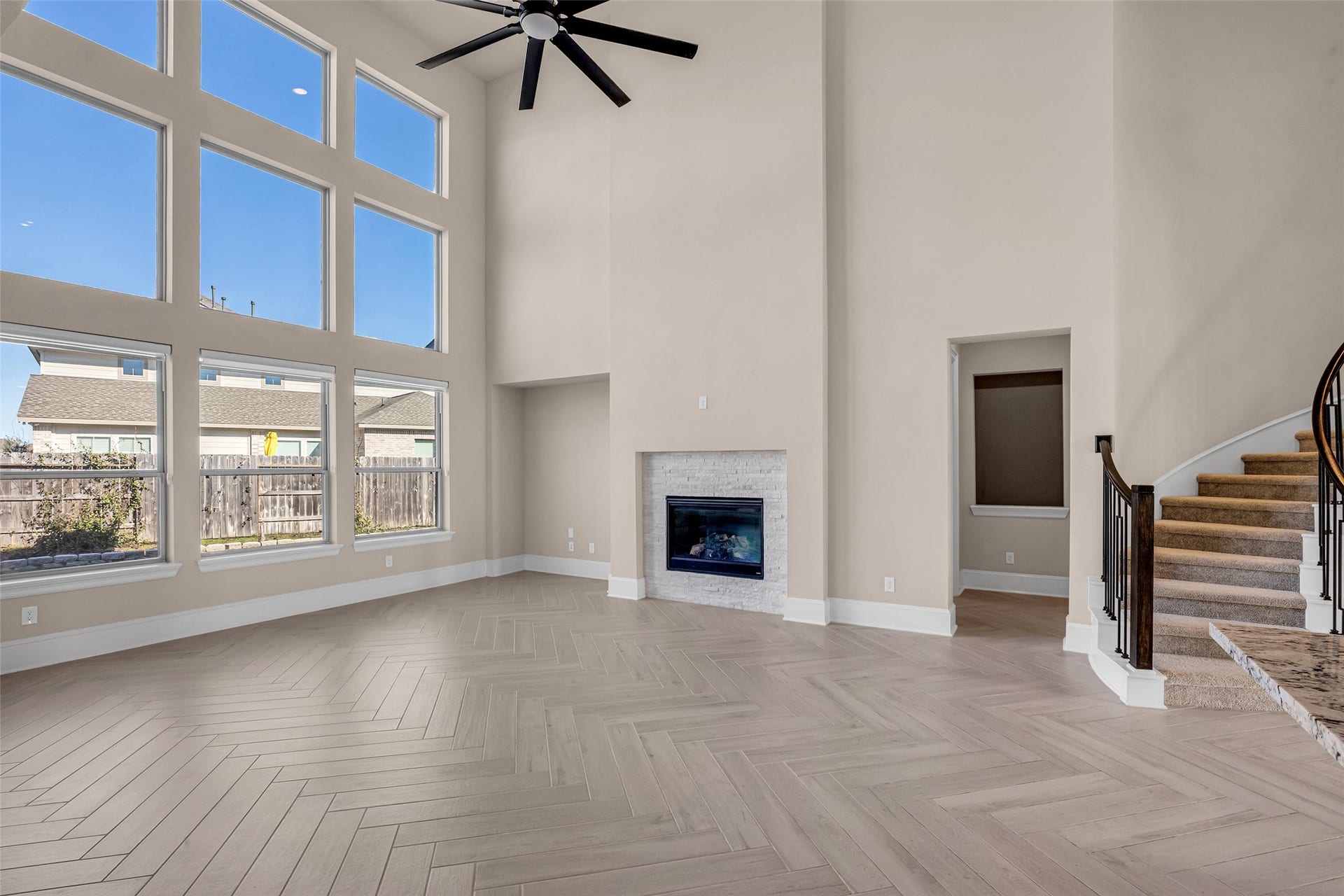 2718 Newbury Island Lane, Katy, TX 77493 This spacious family room is filled with natural light from large windows overlooking the backyard, creating a bright and welcoming environment.