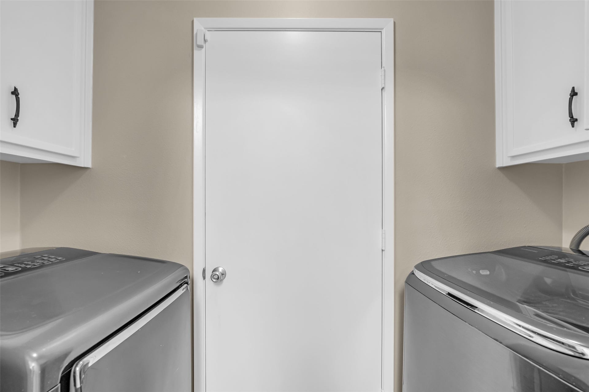11827 Brook Meadows Lane, Meadows Place, TX 77477 Compact laundry room with modern washer and dryer included and cabinets for convenient storage