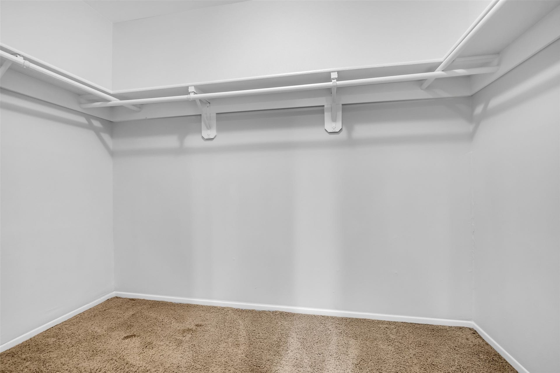 11827 Brook Meadows Lane, Meadows Place, TX 77477 Primary spacious walk-in closet with ample shelving, hanging space and carpet