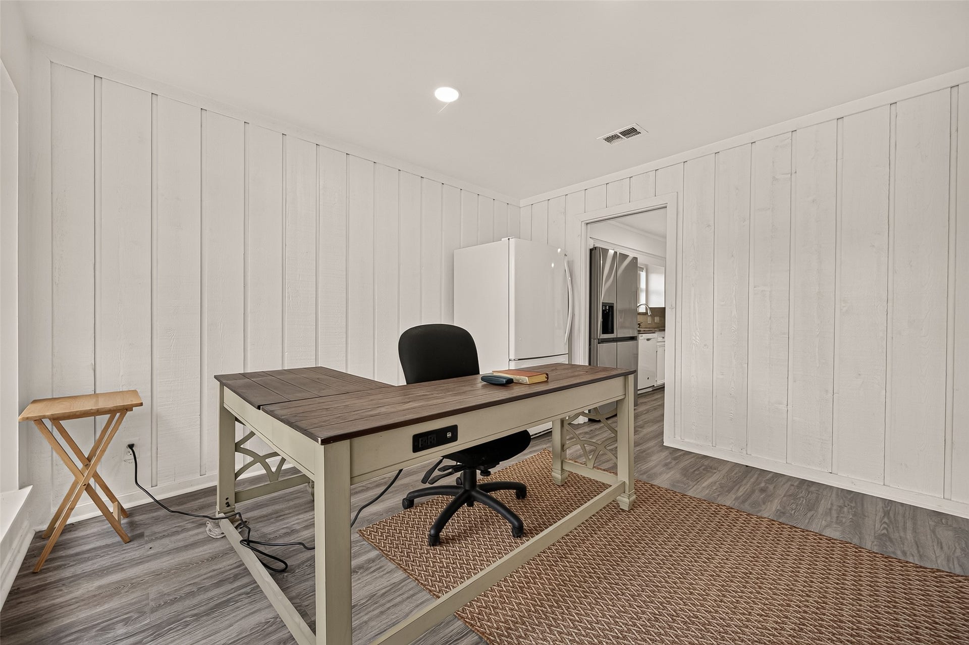2230 S Fountain Valley Drive, Missouri City, TX 77459 Bright and spacious home office or a private dining room space with white wood panel walls.