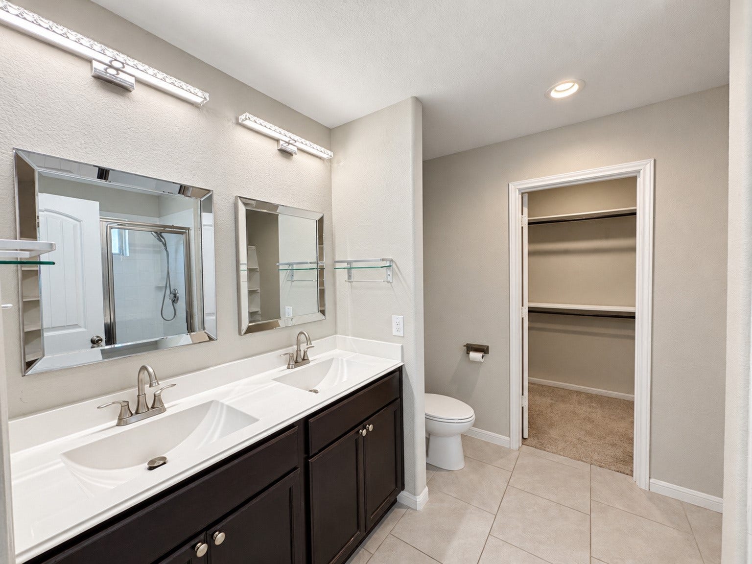 29202 Dunns Creek Court, Katy, TX 77494 Primary bathroom with a double-sink vanity, separate mirrors, and access to the walk-in closet.